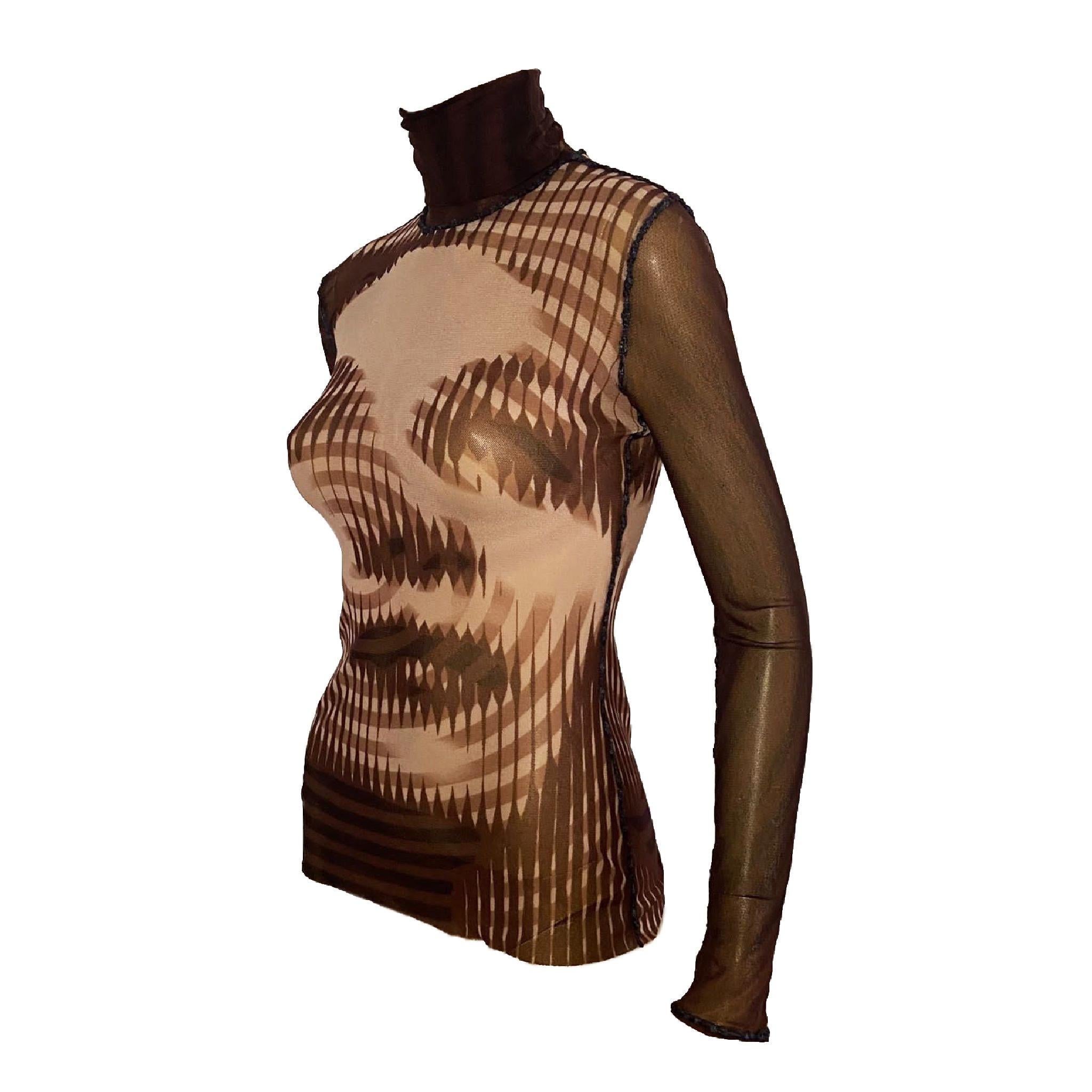 Jean Paul Gaultier maroon long sleeve turtleneck mesh top featuring the iconic Op Art inspired Marlene Dietrich print from Fall/Winter 2001 collection. Small hole (pictured), not visible when worn.

Size label M, can fit bigger sizes as well