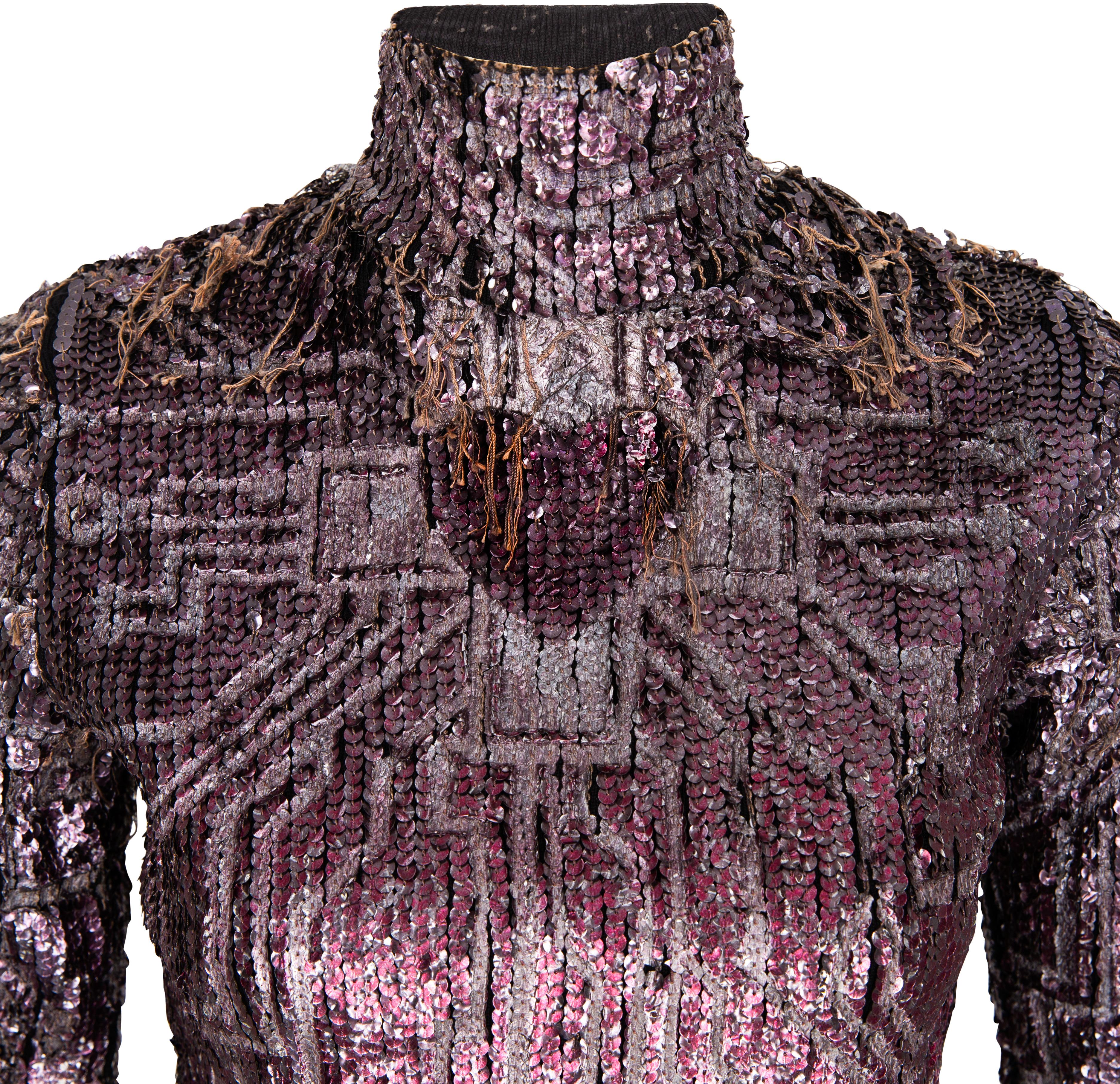 Sequined embellished top adorned with a heart graphic, fringed sequins, and back zipper closure from Jean Paul Gaultier's fall 1995 runway collection modeled by Estelle Lefébure in look eighty-nine. This unique piece is from Jean Paul Gaultier's
