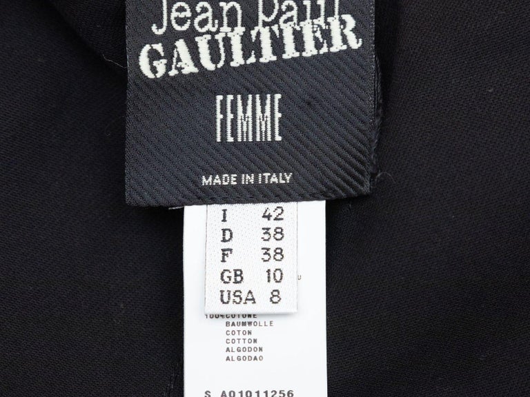 Product Details: Black cotton belt skirt by Jean Paul Gaultier Femme. Dual hip pockets. 28