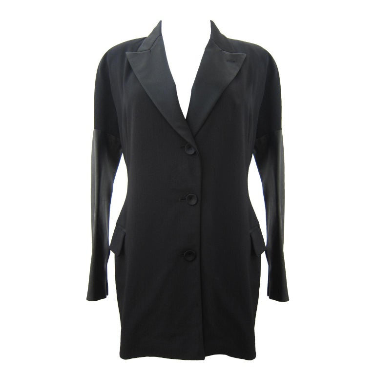 Jean-Paul Gaultier Femme beautifully tailored black jacket with leather detail. 
Satin collar. Two snap buttons on each cuffs.
Size : 8 US 
Sleeve : 76 cm (From neck point) 
Under arm : 48 cm
Length 74 cm