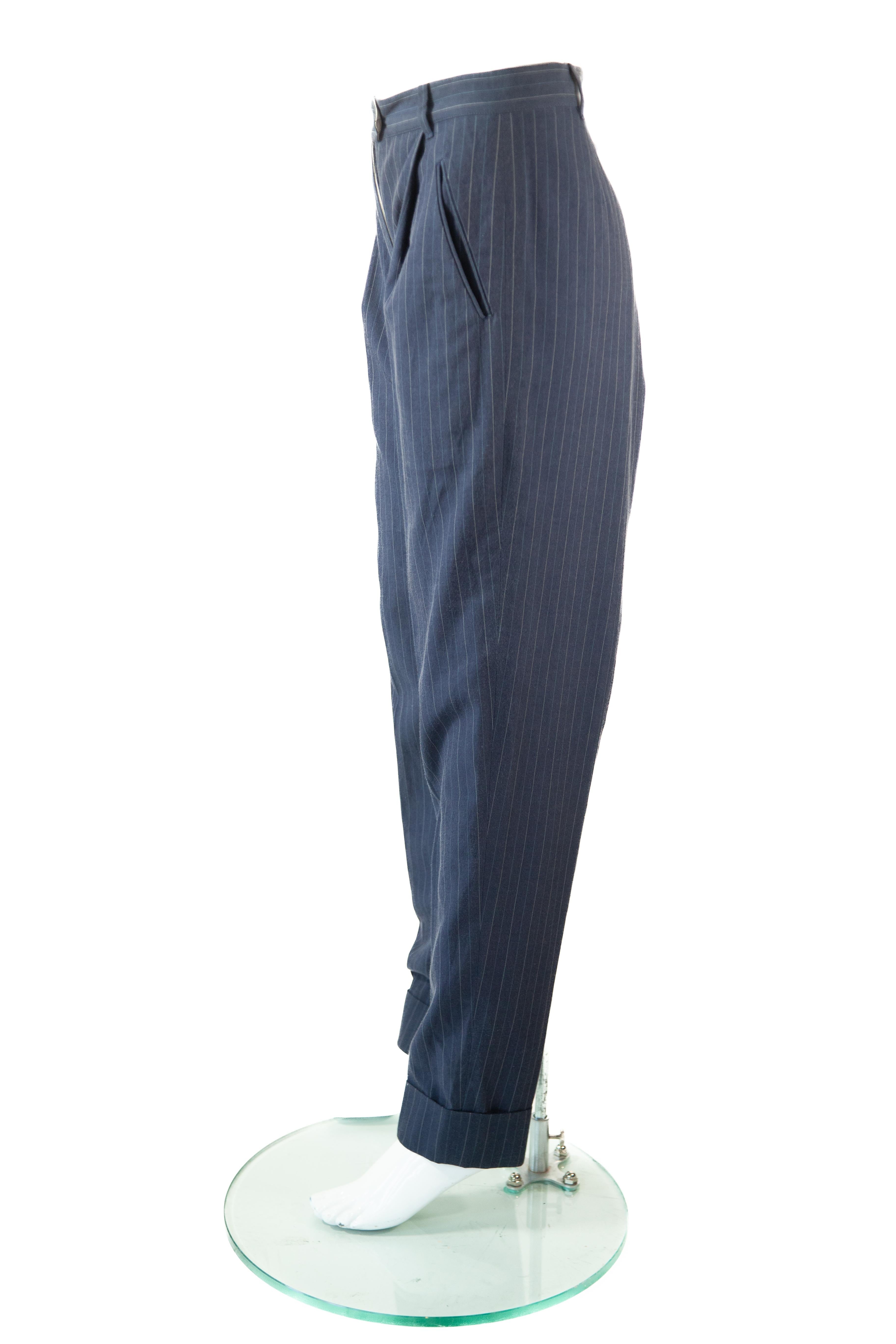 Jean Paul Gaultier navy blue, pin-striped pants with button seems on inner seams of pant that converts into a long skirt

Sz 42

