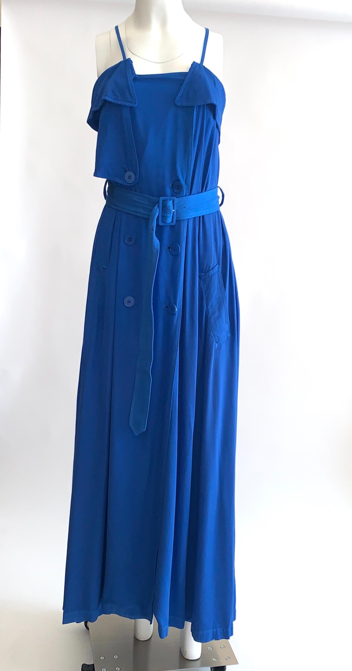 Jean Paul Gaultier Femme blue maxi dress with trench coat detailing. Thin straps can be unsnapped at back to create a criss-cross or halter style. 

Buttons up front. Adjustable belt. Side pockets.

100% rayon.

Made in Italy.

Size It 40, US
