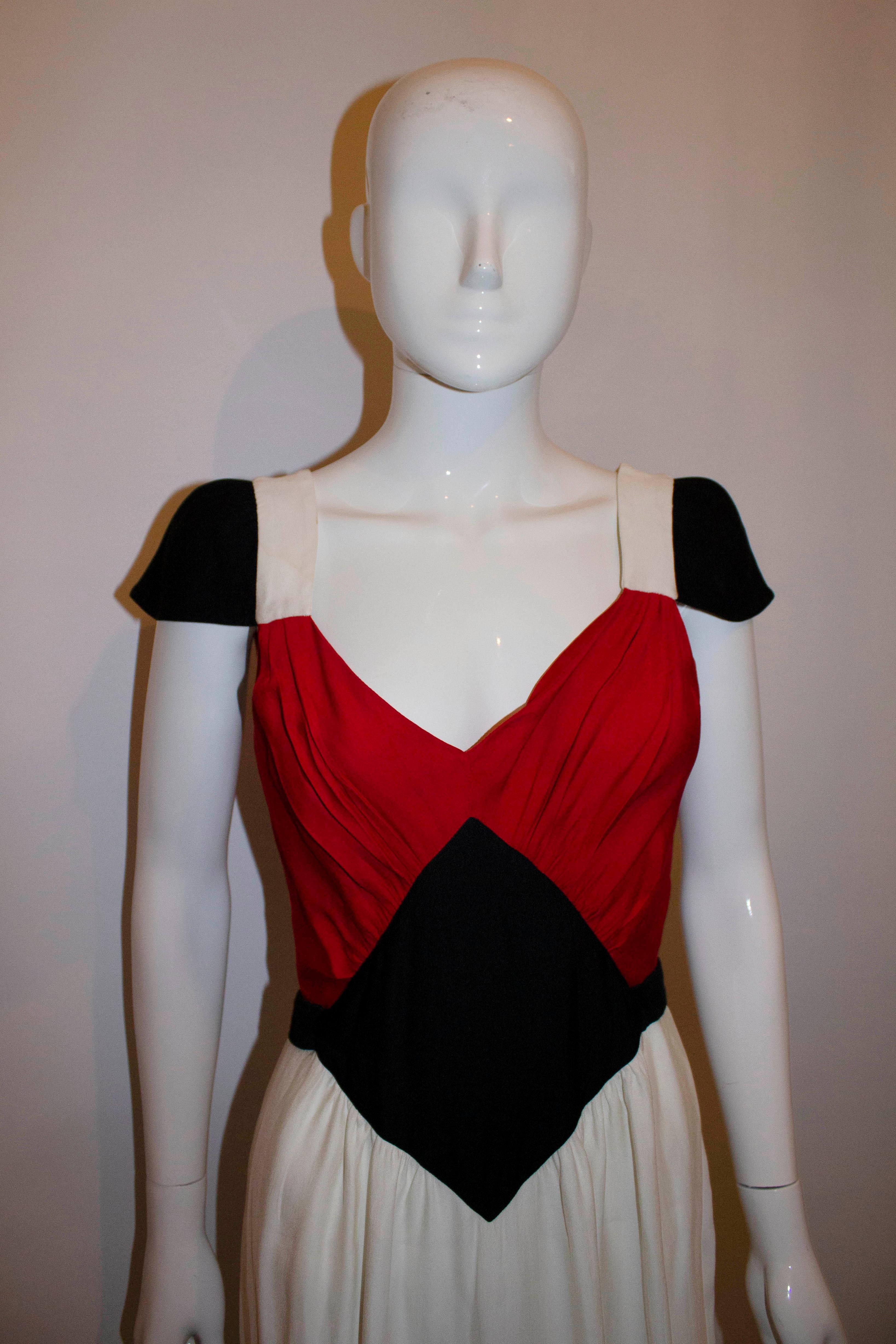 A fun dress by Jean Paul Gaultier , Femme line. The dress has cap sleeves, a central back zip opening, and v neckline. Made in Italy, Size Eu italian 42/UK10. Measurements Bust 37/8'', length 43''