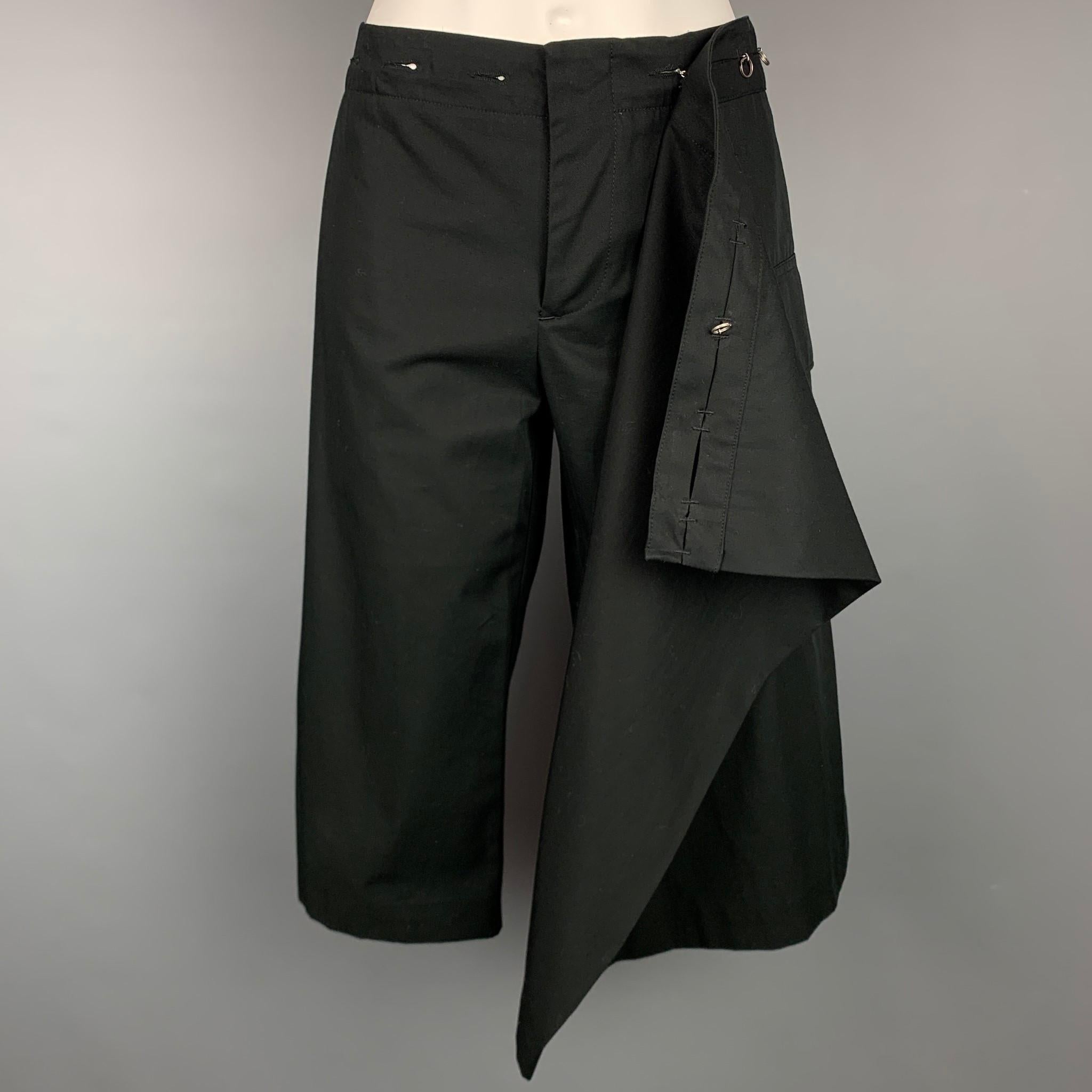 JEAN PAUL GAULTIER FEMME shorts comes in a black twill cotton with a skirt panel design featuring a cargo pocket, front tab, silver tone hardware, and a zip fly closure. Made in Italy. 

Very Good Pre-Owned Condition.
Marked: I 42 / D 38 / F 38 / GB