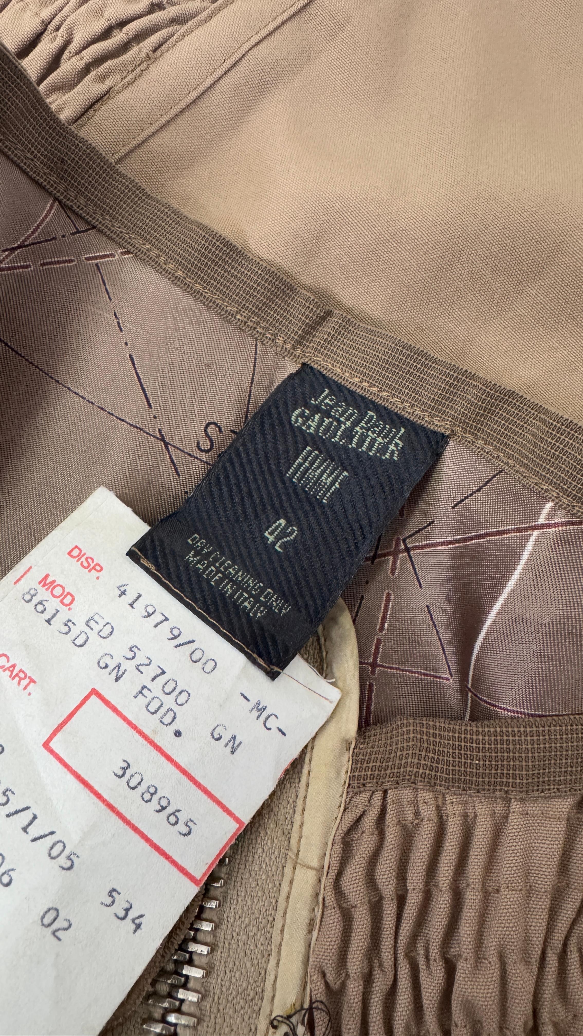 Rare and highly collectible skirt from Jean Paul Gaultier Femme, dating back to the 1990s. Made in Italy from 100% wool, this striking design is a perfect example of Gaultier's avant-garde approach to fashion. The silhouette features smocked stretch