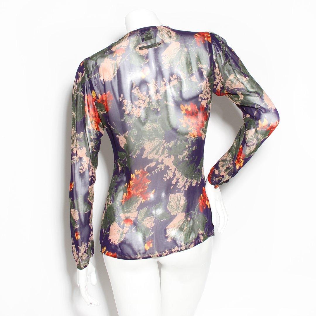 Floral mesh blouse by Jean Paul Gaultier 
Ryon mesh 
Multicolored floral print 
Drawstring scoop neck 
Tie front closure
Longsleeve
Button closure cuff
Made in Italy
Condition: Great, small snags by collar (see photos)

Size/Measurements: