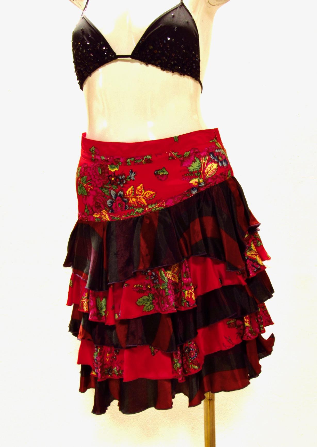 This ultra feminine red floral satiny soft skirt comes from vintage Jean Paul Gaultier. A fitted waist with side zip falls to tiered layers of sheer black mixed with red florals.  