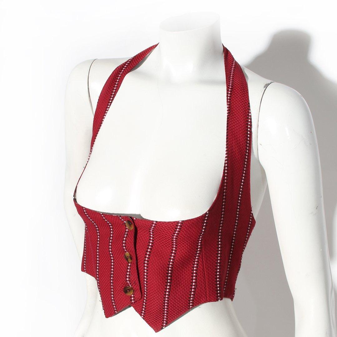 Jean Paul Gaultier Vest 
Vintage 
Circa early 1980's 
Made in Italy 
Cranberry Red
Geometric black and white pattern 
Halter style strap 
Three tortoise shell buttons down front of vest
Interior lined in black and white gingham print
Fabric