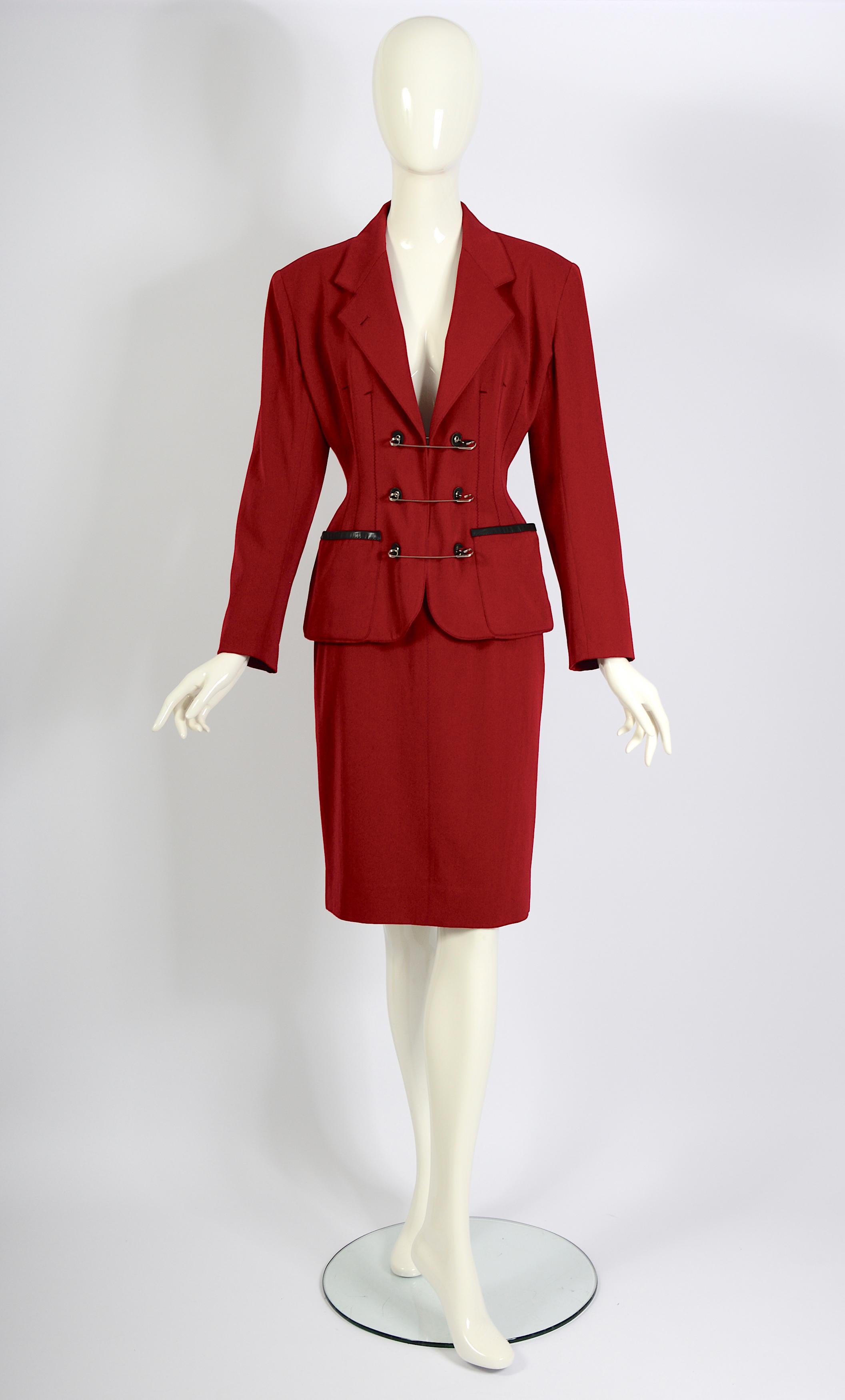 Jean Paul Gaultier Gibo Vintage 80s Red Wool Safety Pin Jacket & Skirt Suit
This is a highly collectible Jean Paul Gaultier produced by Gibo skirt suit in pristine condition. Crafted from luxurious deep red wool, the ensemble features a oversized
