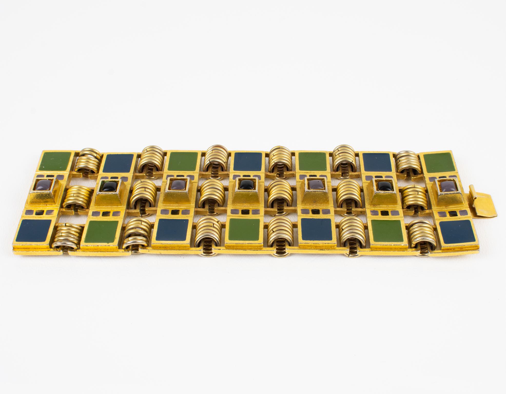 This impressive and rare Jean Paul Gaultier Paris massive link bracelet features a heavy gilded metal geometric framing topped with kaki green and navy blue enamel sections and embellished with navy blue and mouse gray enamel cabochons. The bracelet
