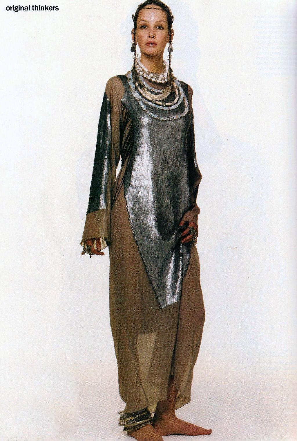 Jean Paul Gaultier; Loosely fit maxi dress in a muted green cotton with silver sequin motifs with beaded hoops and lace up corset style fastenings at the sides.   

Spring-Summer 1994  

'It's my way of merging the tight silhouette of the eighties