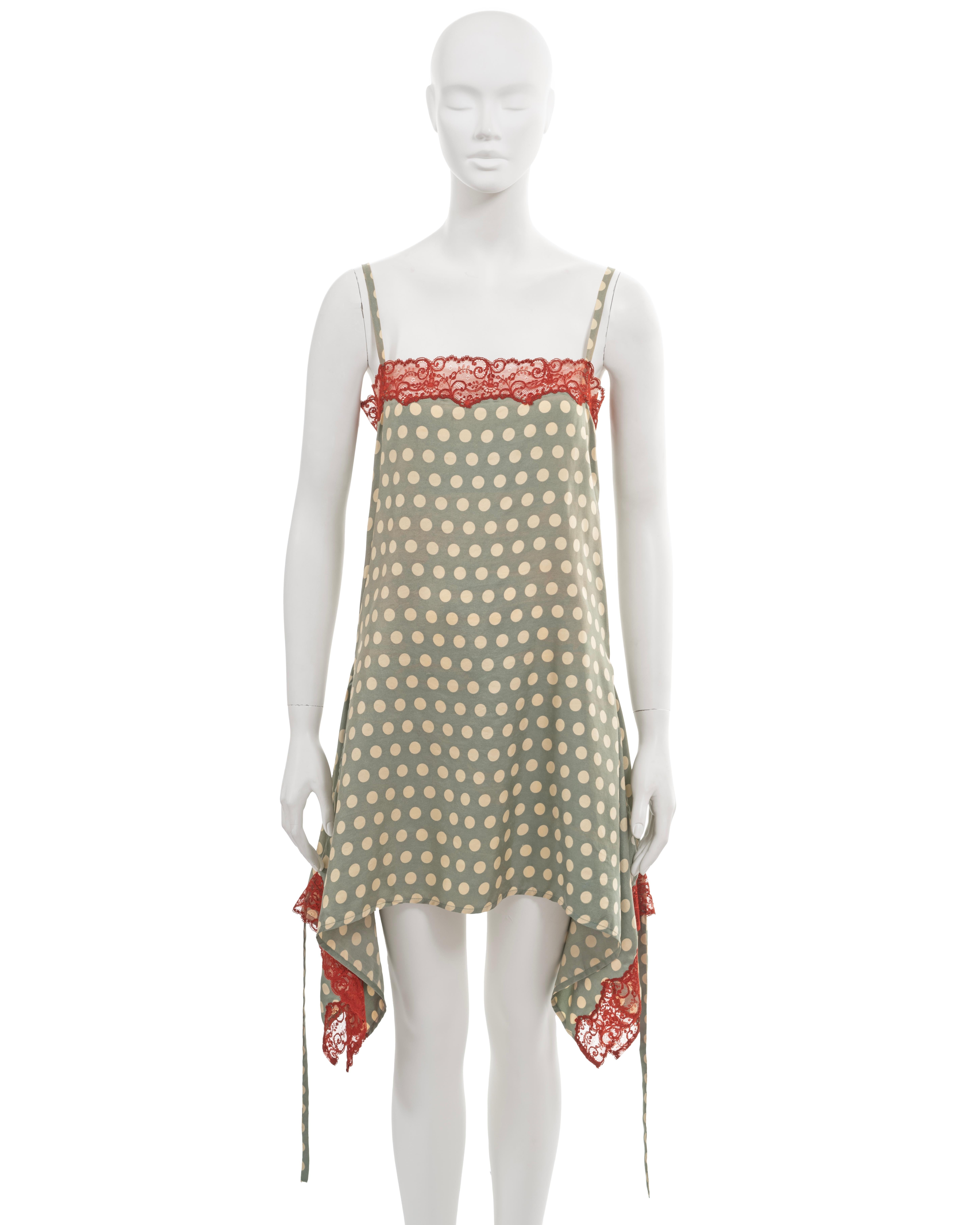 ▪ Archival Jean Paul Gaultier slip dress
▪ Spring-Summer 1992
▪ Sage green silk with allover ivory polkadot motif
▪ Red lace trim featured on the neck and hemline
▪ The skirt has wider panels on the hips, that can be fastened with ties at the back