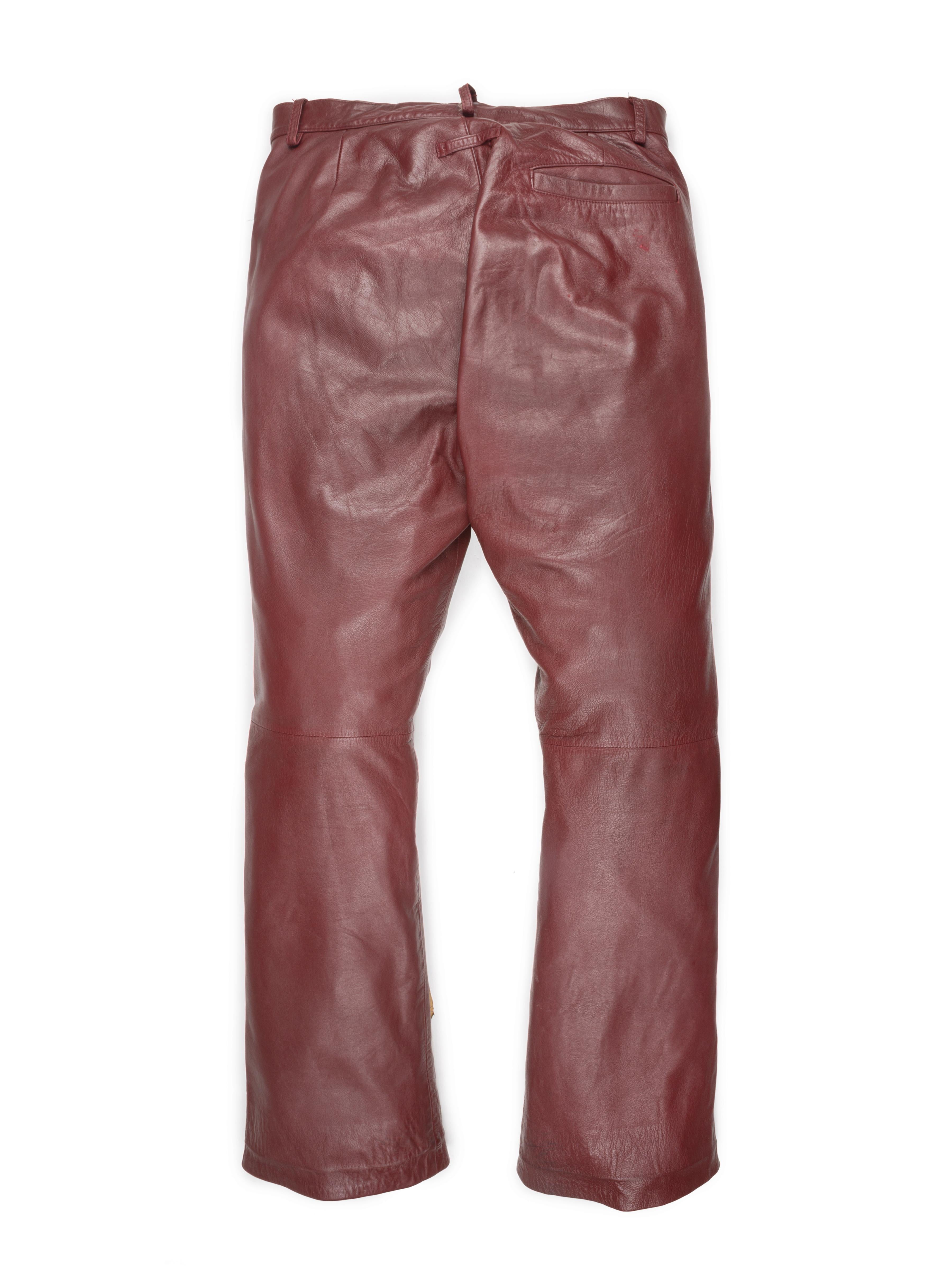 These red leather lambskin pants feature subtle moto-details, such as the snap closure at the waist and the zipper-pull pockets.

Condition: 8/10. 

Tagged size: 48

Waist: 15in

Rise: 11in

Thigh: 11in

Inseam: 29in

Hem: 8.5in