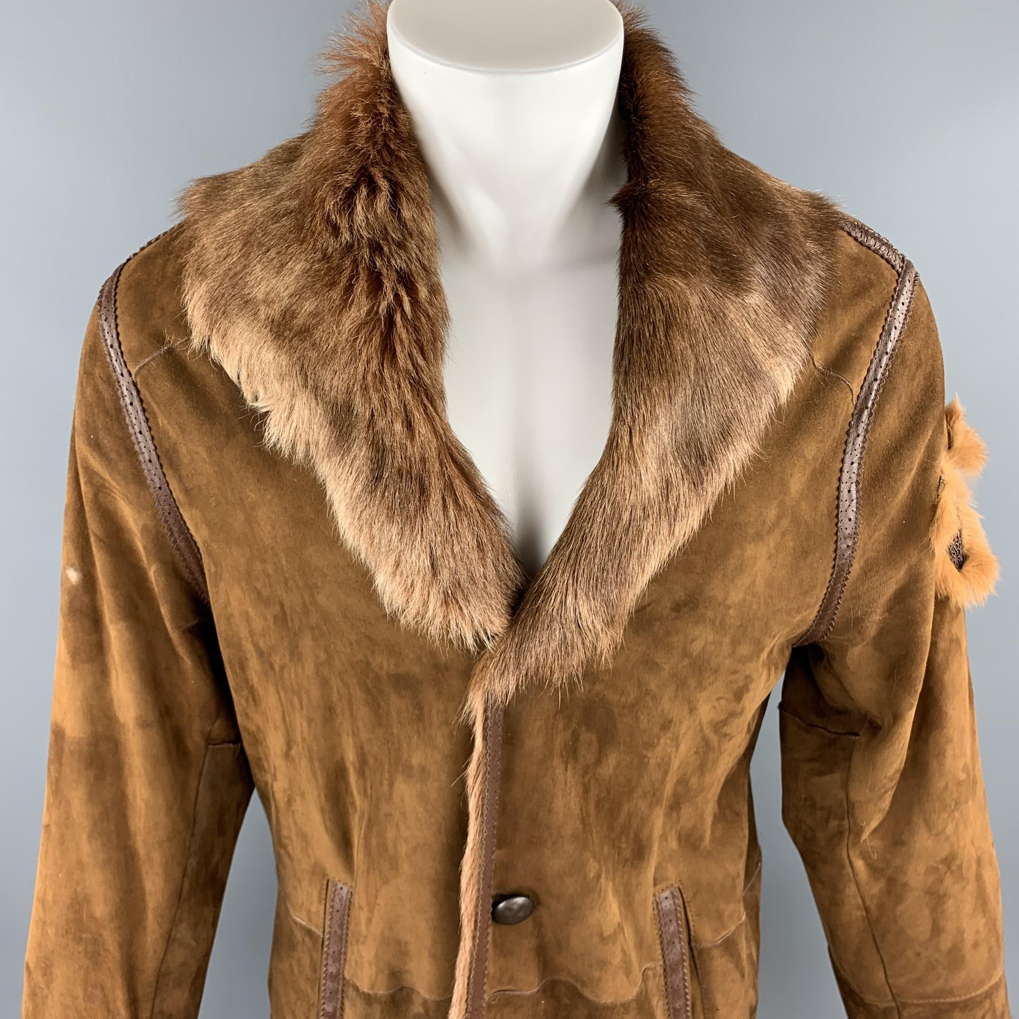 Vintage JEANS PAUL GAULTIER coat comes in tan suede with a full fur interior, wide fur collar, brown perforated brogue piping, slit pockets, hammered buttons, and bull shaped patch. Missing button and wear throughout suede. 

Good Pre-Owned