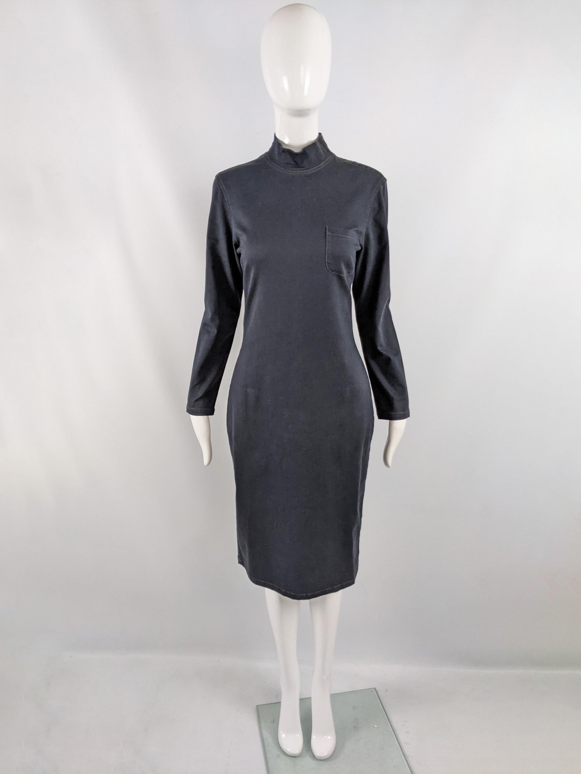 An excellent vintage Jean Paul Gaultier shift dress from the 90s. In a darkest blue, almost black stretch denim fabric with a mock neck, long sleeves and a zip opening at the side of the neck. 

Size: Unlabelled; measures roughly like a modern