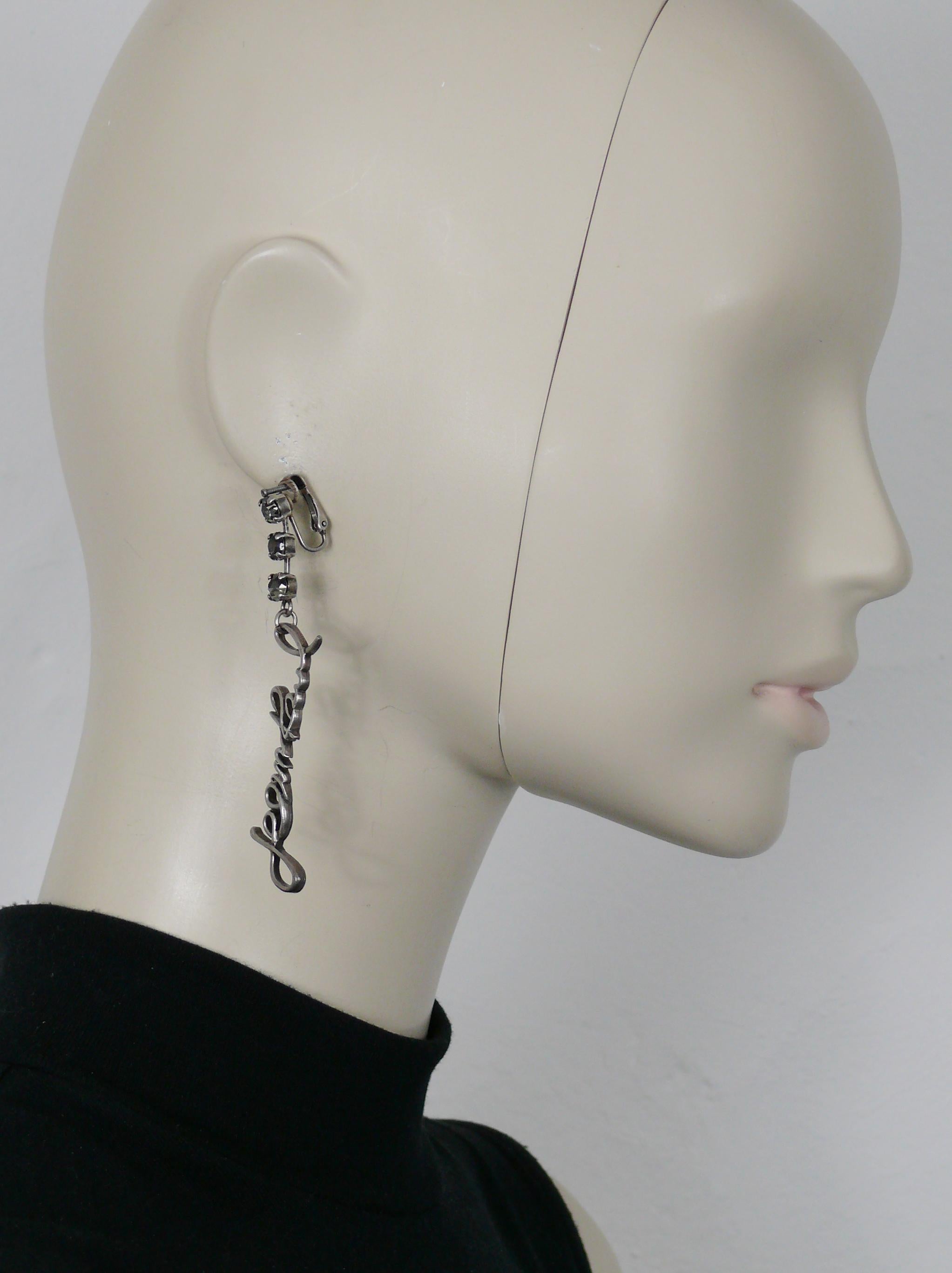 JEAN PAUL GAULTIER antiqued silver tone dangling earrings (clip-on) embellished with crystals and featuring cursive signatures JEAN PAUL and GAULTIER.

Unmarked.

Indicative measurements : max. length approx. 8 cm (3.15 inches) / max. width approx.