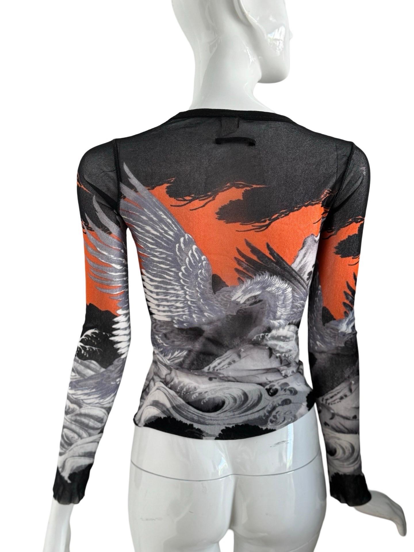 Jean Paul Gaultier Soleil mesh top in a sought after eagle tattoo design in orange, black and greys.  The design has been previously seen worn as a dress by Kendall Jenner. This top is in excellent condition, their is one small hole in the back.