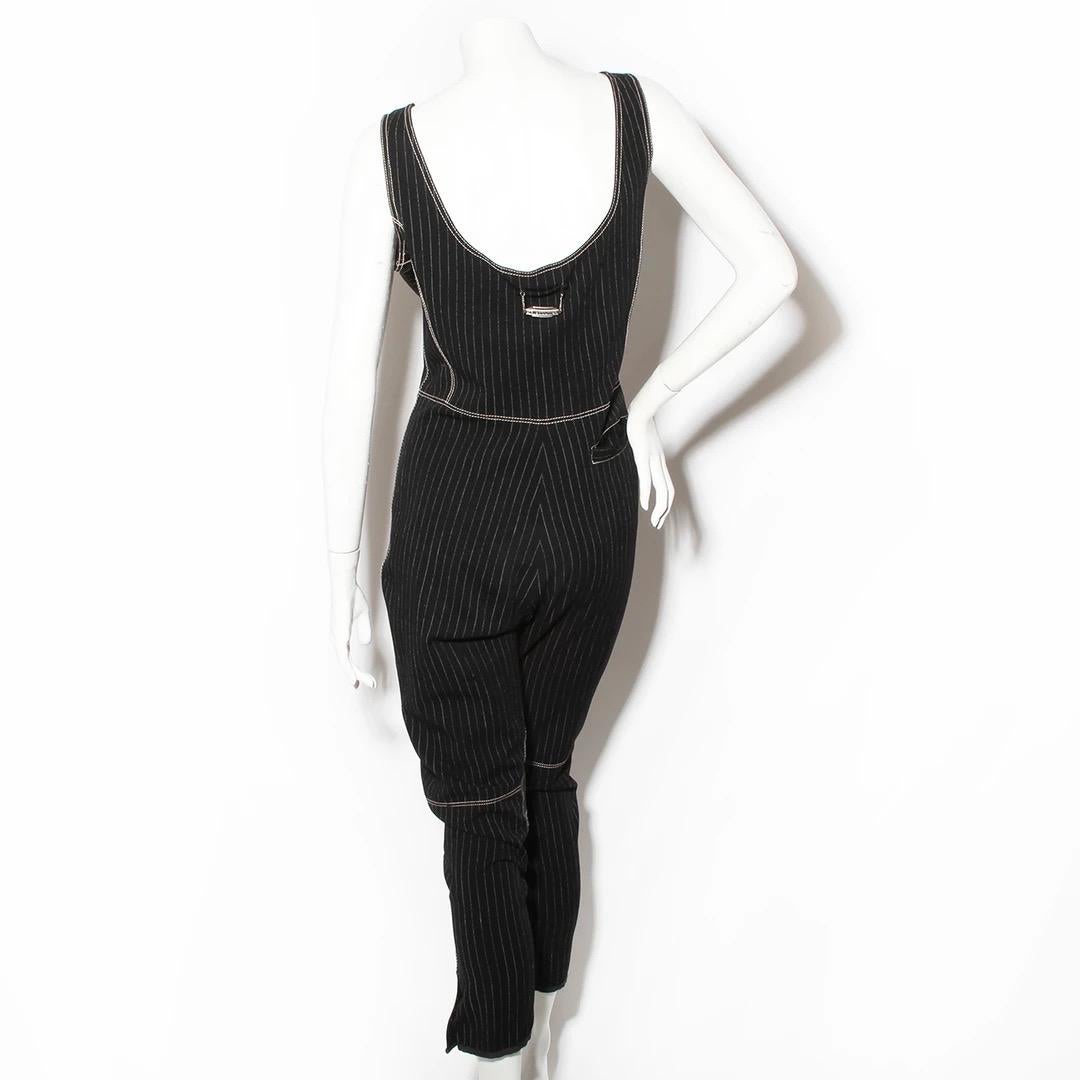 Jumpsuit by Jean Paul Gaultier 
Tank top 
Front hip pockets  
White stitching outliines 
Tapered leg with velcro fastening on the ankles
Suede knee cap details
JPG brand loop in the back
Stretchy Fabric
Rayon and cotton composition 
Front zipper