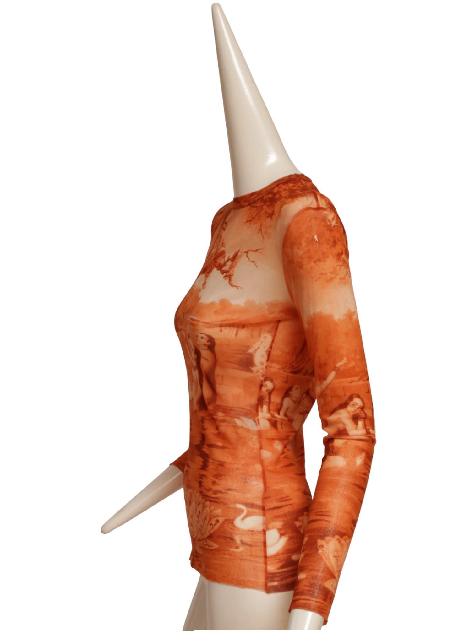 From the Iconic mesh series in S/S 94 by Jean Paul Gaultier this orange mesh long sleeve top has an image of Krishna sitting in a tree. 
