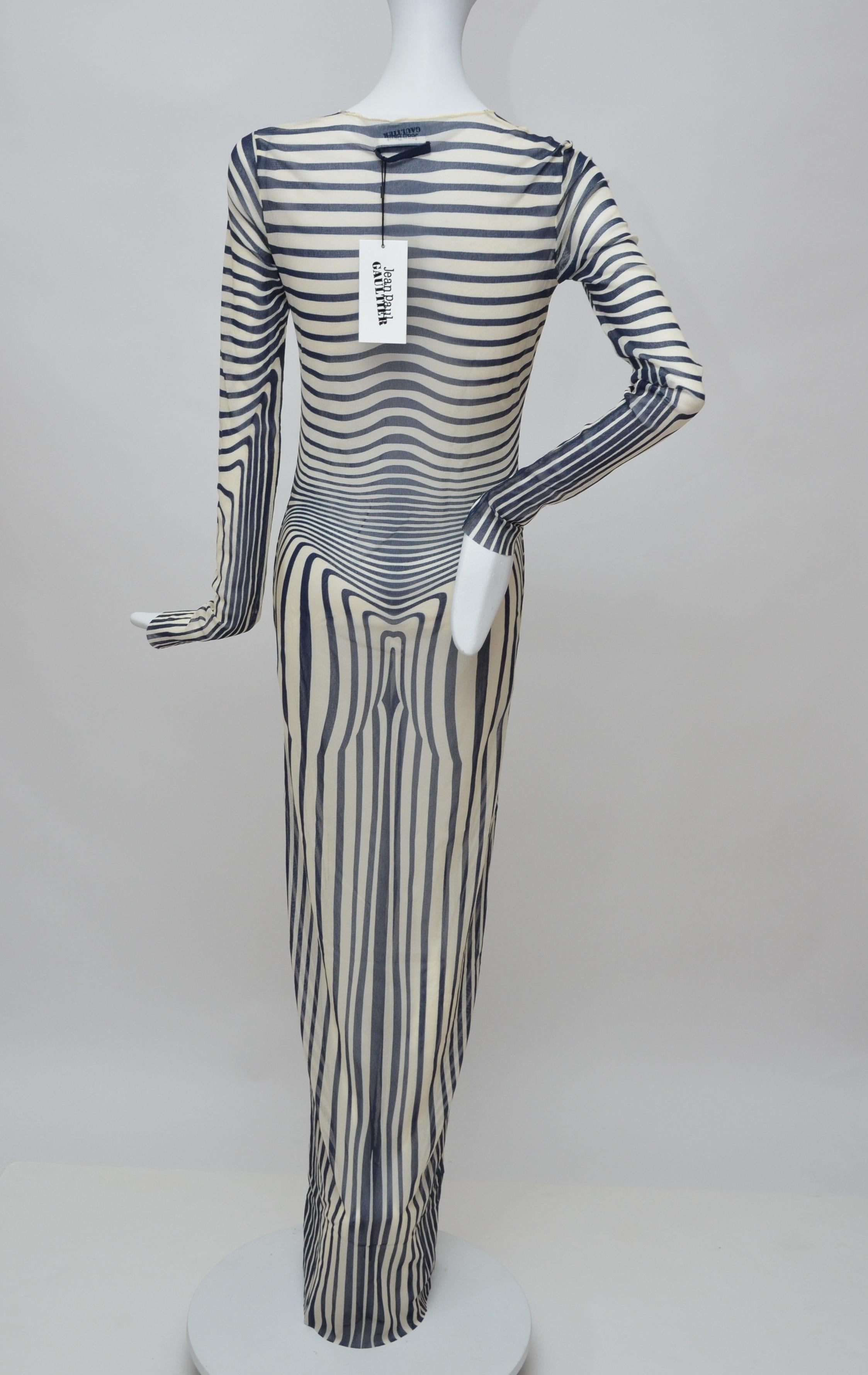 Dress is from Jean Paul Gaultier’s famous sheer, tattoo print  ready to wear collection: Les Marins by Jean Paul Gaultier.
This collection was presented  by five different design teams and their various aesthetics but  the collection itself is