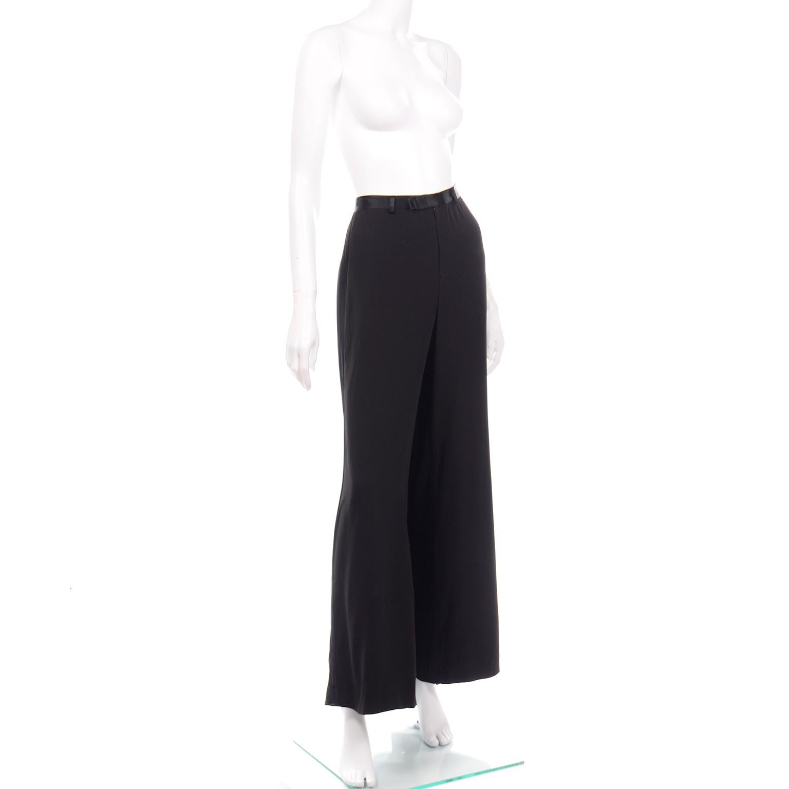This gorgeous Jean Paul Gaultier Classiques long black evening skirt has a train in back and the front is split to reveal wide leg trousers attached underneath. This black crepe skirt has a satin Waistband with belt loops, and closes with a front