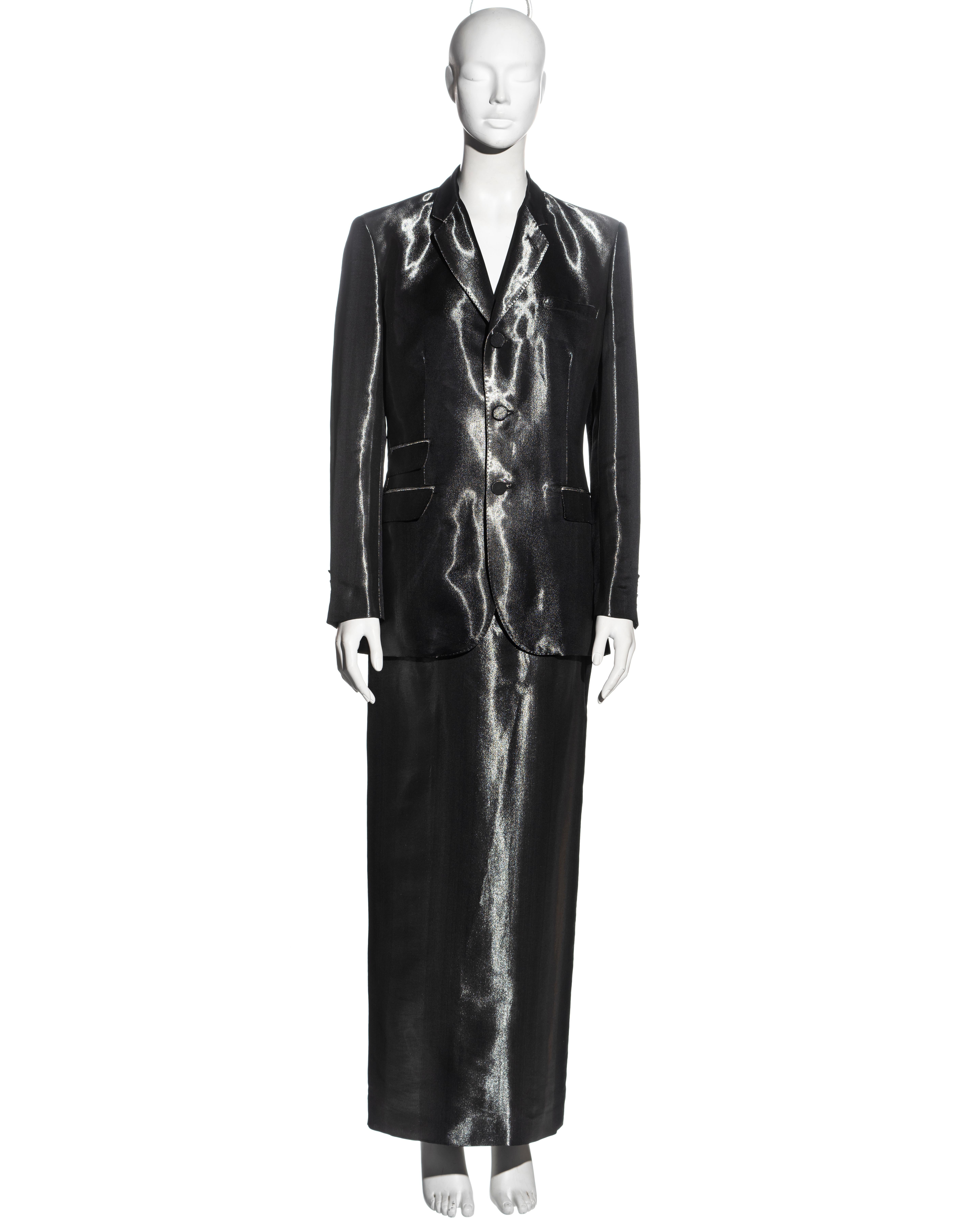 ▪ Jean Paul Gaultier skirt suit
▪ Striped metallic gunmetal silk-rayon 
▪ Single-breasted blazer jacket 
▪ Matching fabric buttons
▪ Maxi skirt with high slit at the centre-back with button closures 
▪ Skirt: IT 42 - FR 38 - UK 10 / Jacket: IT 44 -