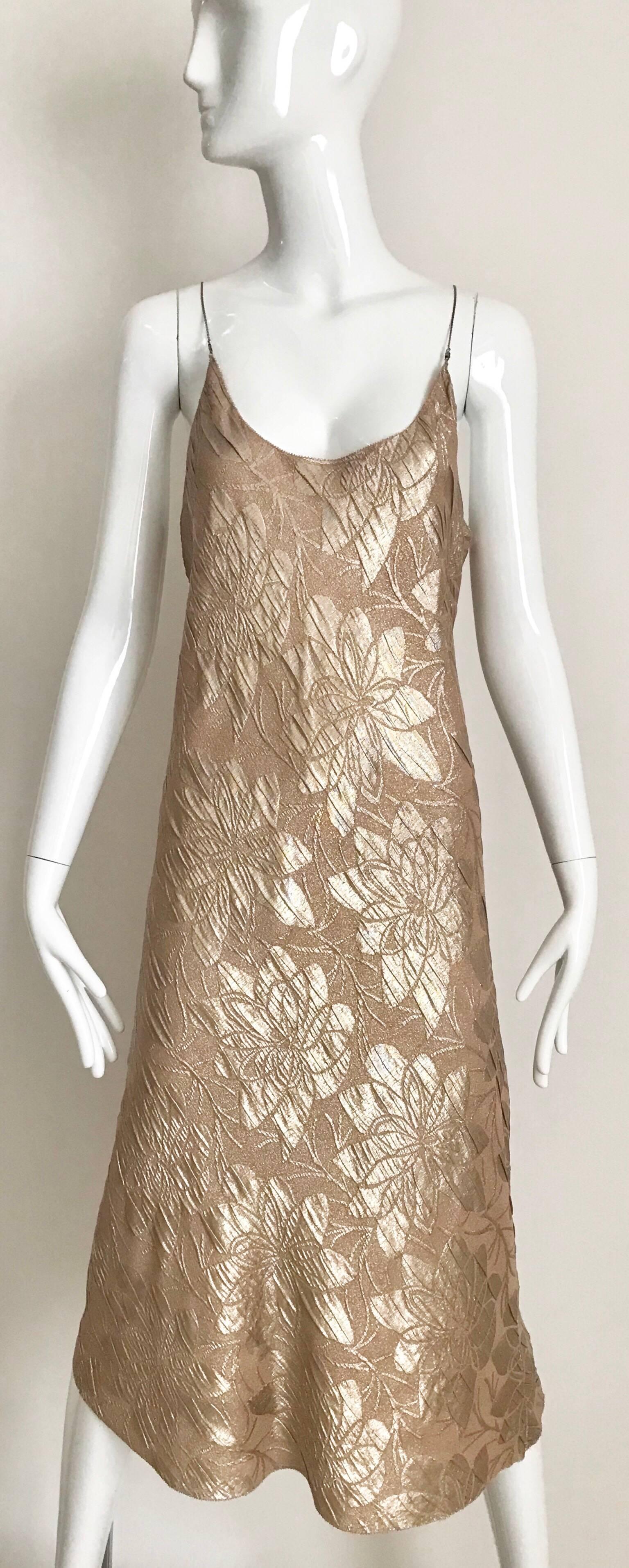 Vintage Jean Paul Gaultier metallic light brown bias cut silk jacquard slip dress with chain strap and silk cropped Jacket. Dress cut in bias.
Size: 4 or 6
Bust: 36 inches/ waist 36 inches/ Hip: 39 inches/ Dress length: 46 inches
Jacket measurement: