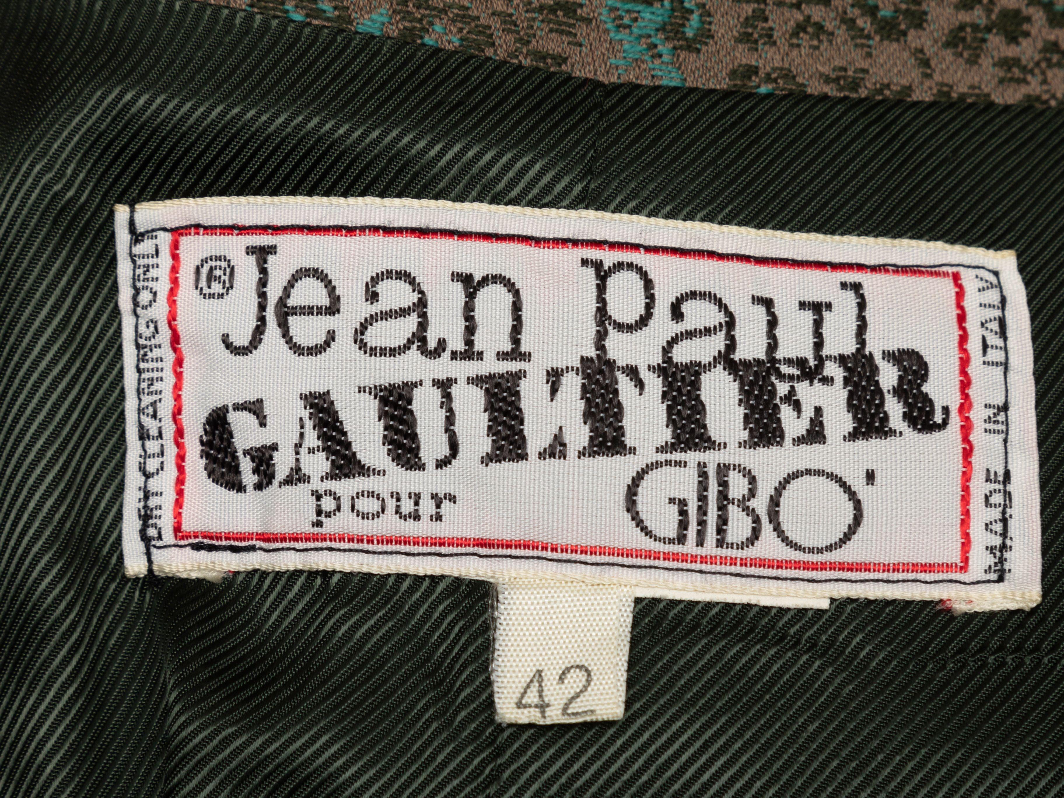 Product Details: olive and multicolor floral jacquard double-breasted blazer by Jean Paul Gaultier. Peaked lapel. Three welt pockets. Button closures at front. Designer size 42. 36