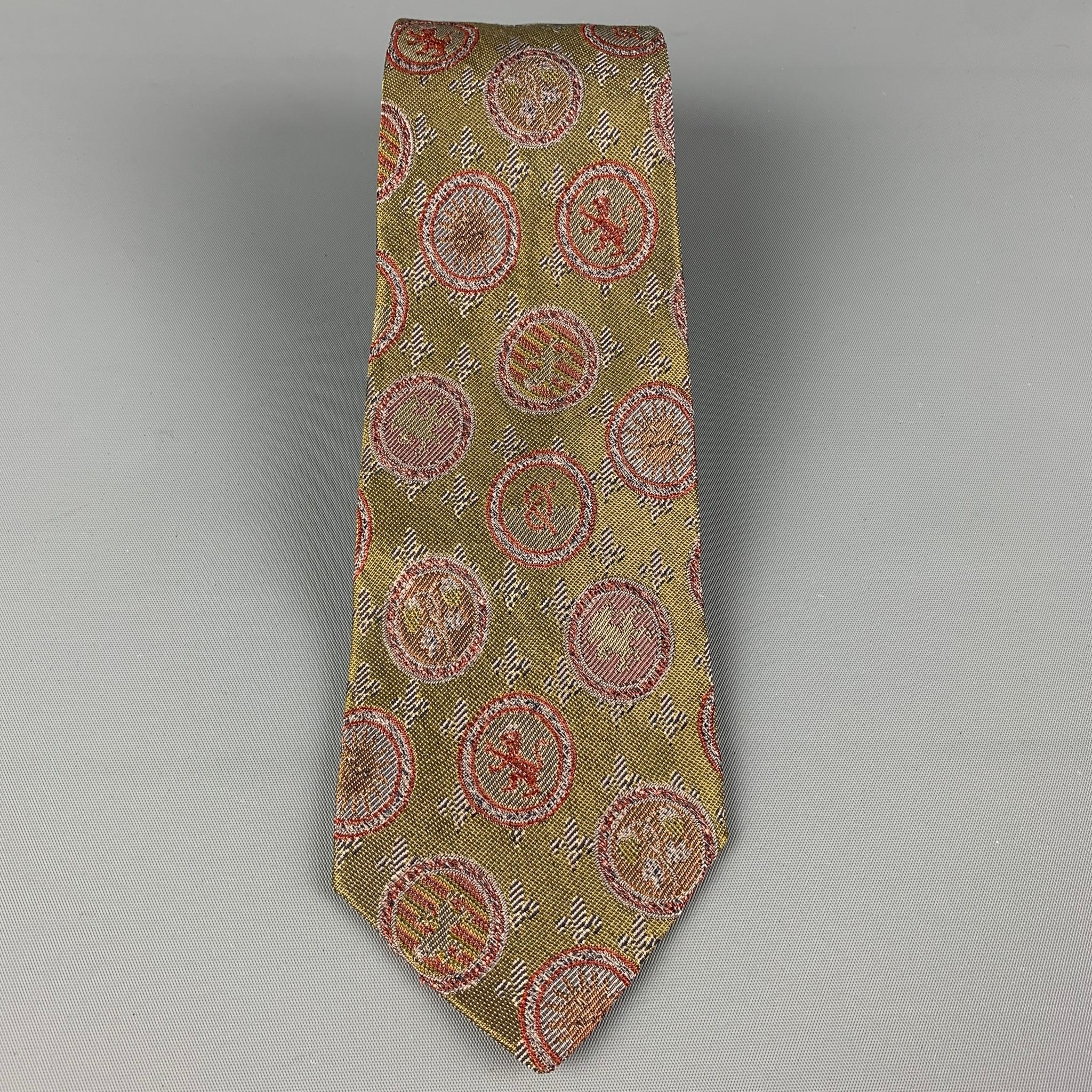 JEAN PAUL GAULTIER necktie comes in a olive & red silk blend with a all over crest print. Made in Italy .

Very Good Pre-Owned Condition.

Width: 3.25 in.
Length: 60 in. 