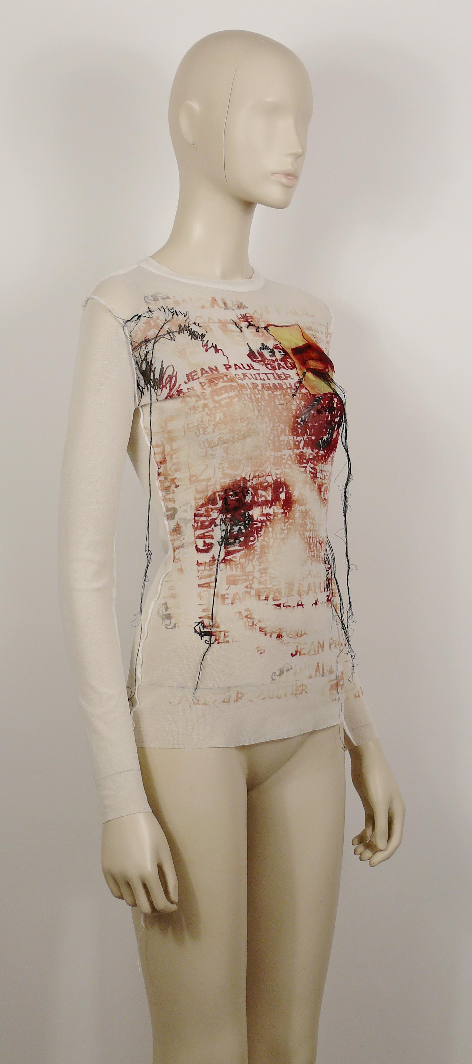 JEAN PAUL GAULTIER Maille Femme white sheer mesh top featuring and eye applique, an optical illusition portrait, JEAN PAUL GAULTIER wording and threads.

Label reads JEAN PAUL GAULTIER Maille Femme Made in Italy.

Composition tag reads : 100%