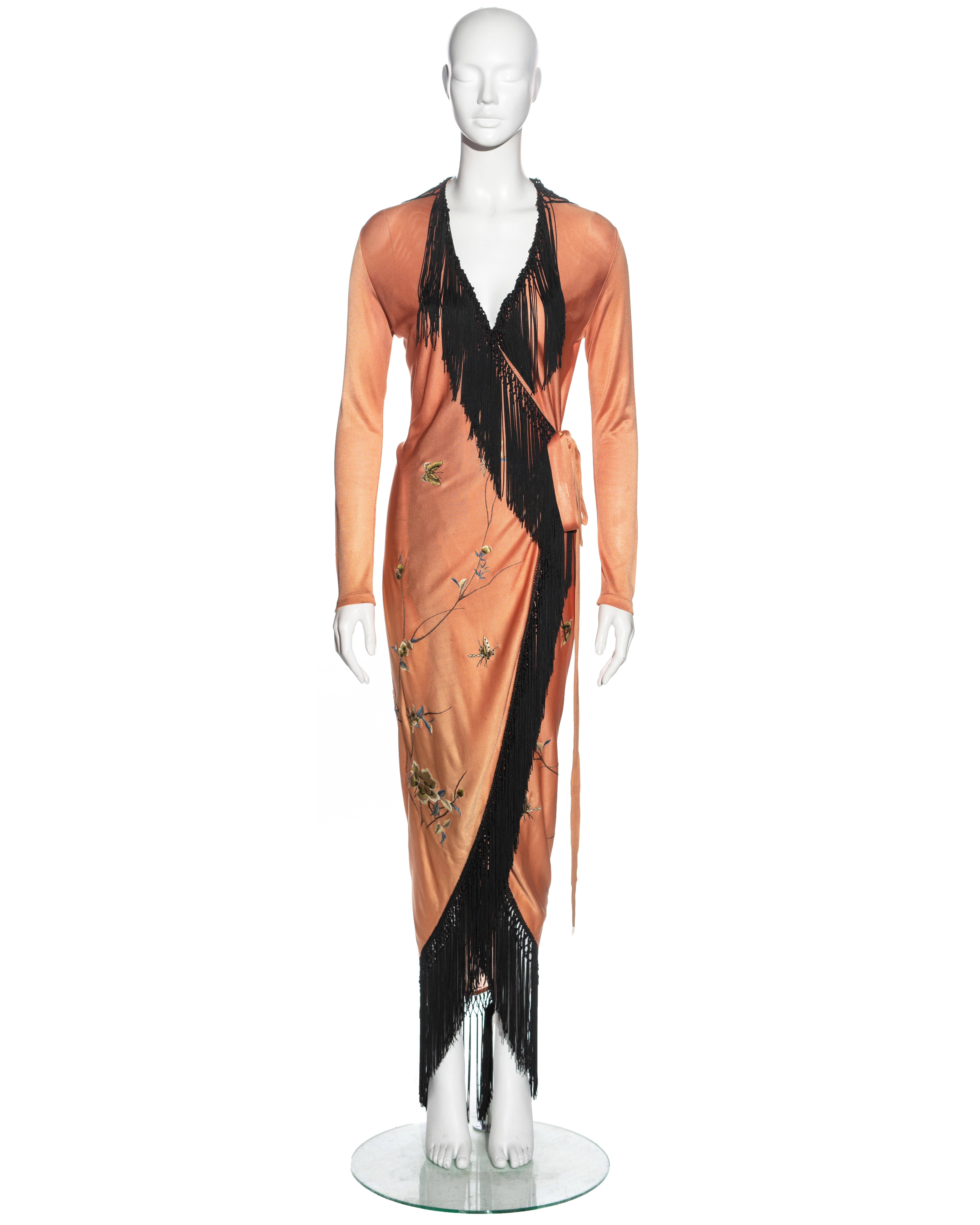 ▪ Jean Paul Gaultier wrap dress
▪ Sold by One of a Kind Archive
▪ Constructed from a pale peach viscose knitted fabric 
▪ Hand-knotted black silk fringes 
▪ Floral embroidery 
▪ Wrap fastening with two waist ties at the waist 
▪ Size IT 42 - FR 38 -