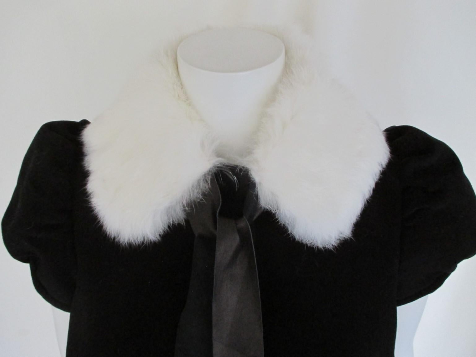 This vintage black jacket/bolero is made of cotton, feels like velvet, with lapin collar, with puffed sleeves, 3 buttons and 2 leather closing frings.
Its in pre-loved condition, light and easy to wear.
Size fits as small, see section