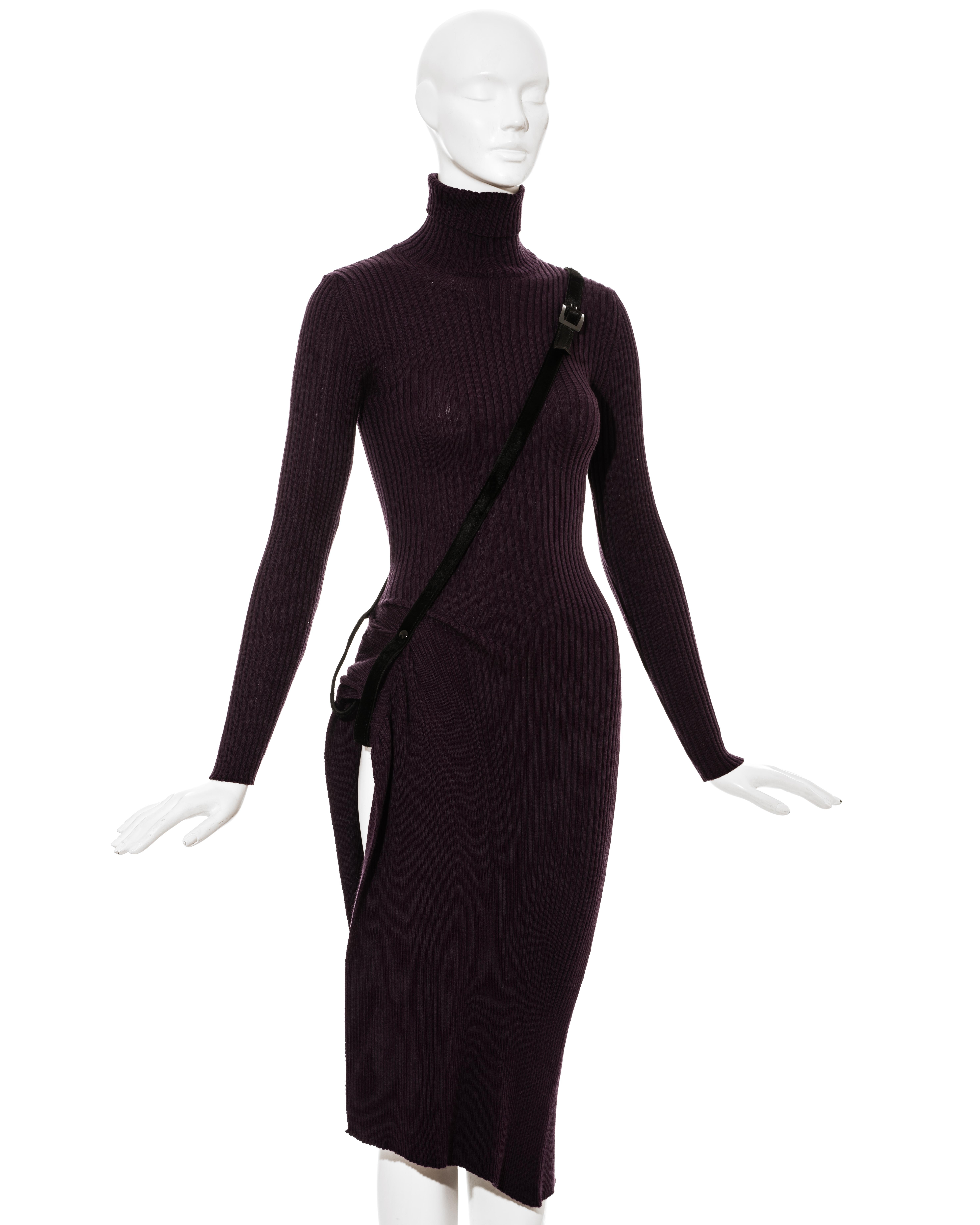 Jean Paul Gaultier plum rib-knit wool dress with black pony hair harness belt; creates a leg slit on one side. 

Fall-Winter 2002 