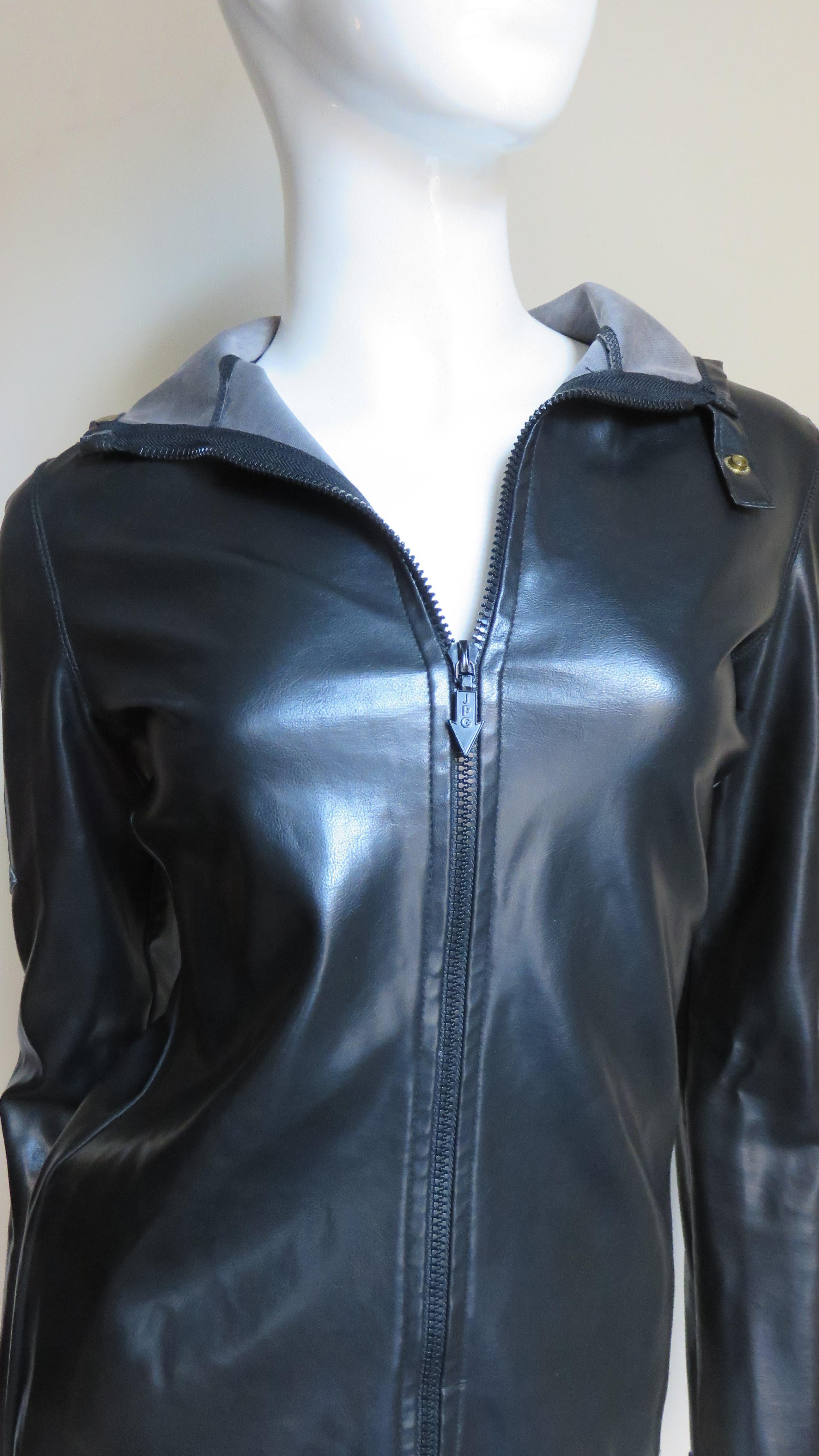 A fabulous black polyurethane jacket from Jean Paul Gaultier's JPG collection.  It has a hood, snap tab at the neck and long sleeves with padded arrow appliques along the upper arms, a front zipper and it is unlined.
Fits Extra Small, Small.  Marked