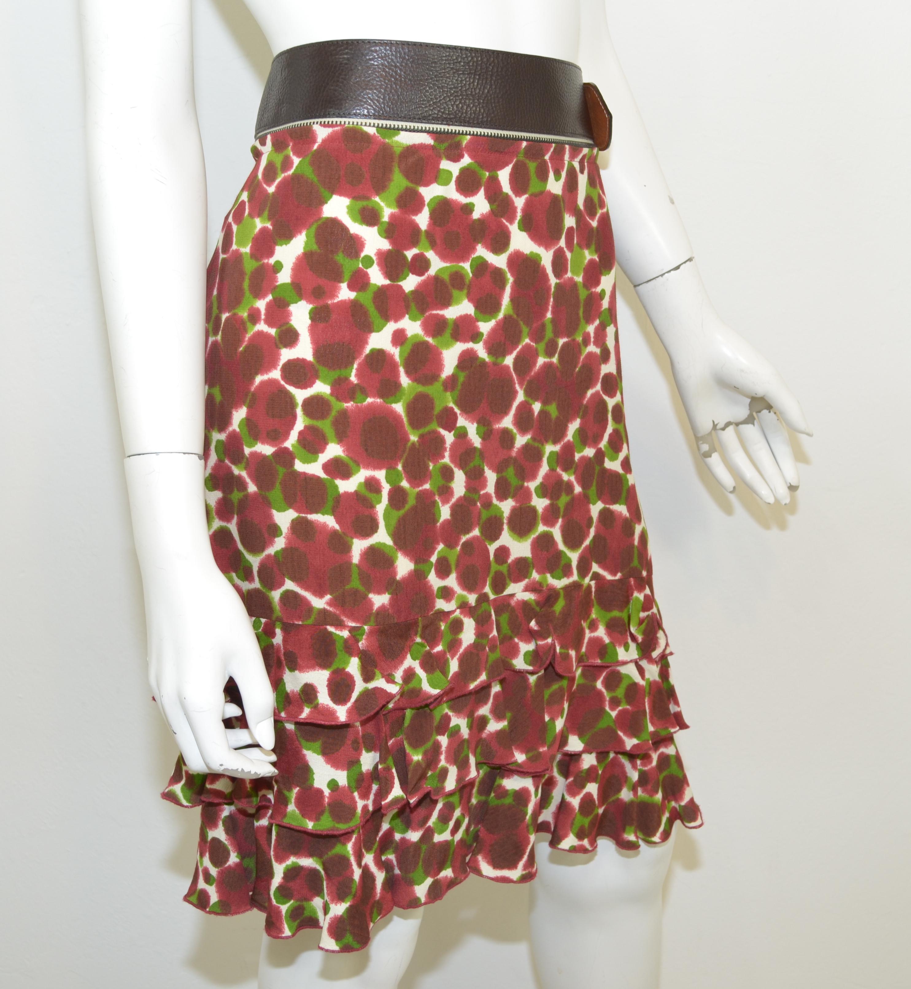 Jean Paul Gaultier skirt is featured in a maroon, green, and cream print with a ruffled hem, side zipper and button closure, and an optional belt. Skirt is composed with 100% rayon, made in Italy. 

Measurements:
Waist 32'', Hips 37'', Length 22''