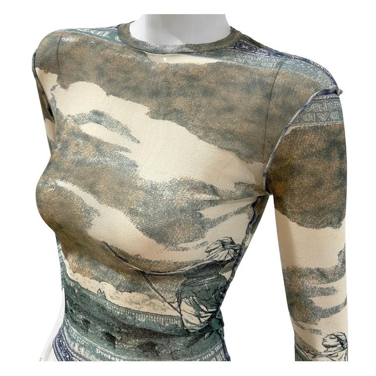 Print Mesh Top Jean Paul Gaultier Maille
Spring / Summer 1994
Made in Italy
Sky and statue print
Long sleeves
Mesh fabric is stretchy
Scoop neckline
Fabric Composition; 100% Polyamide
Excellent vintage condition; no visible wear throughout top (see