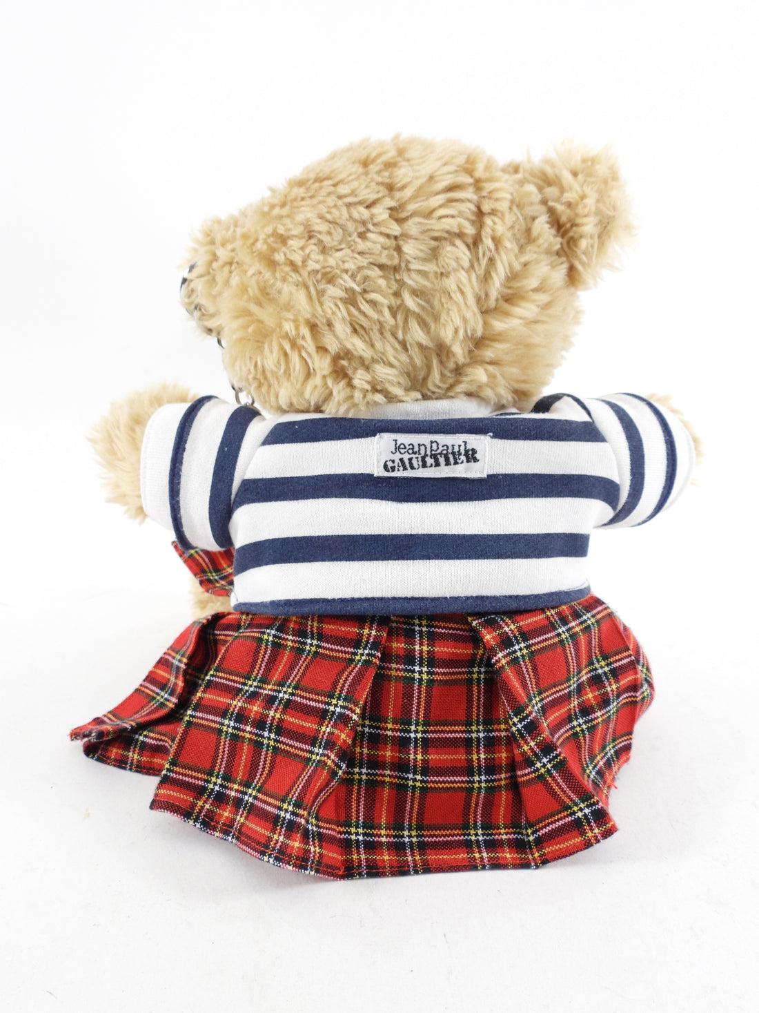 Jean Paul Gaultier Teddy Bear with Striped T-Shirt.  Plush novelty bear with chain detail, kilt, and t-shirt.

NEW in bag!

In 2012 the De Young Museum in San Francisco featured a very large exhibit of his work and along with that came the release
