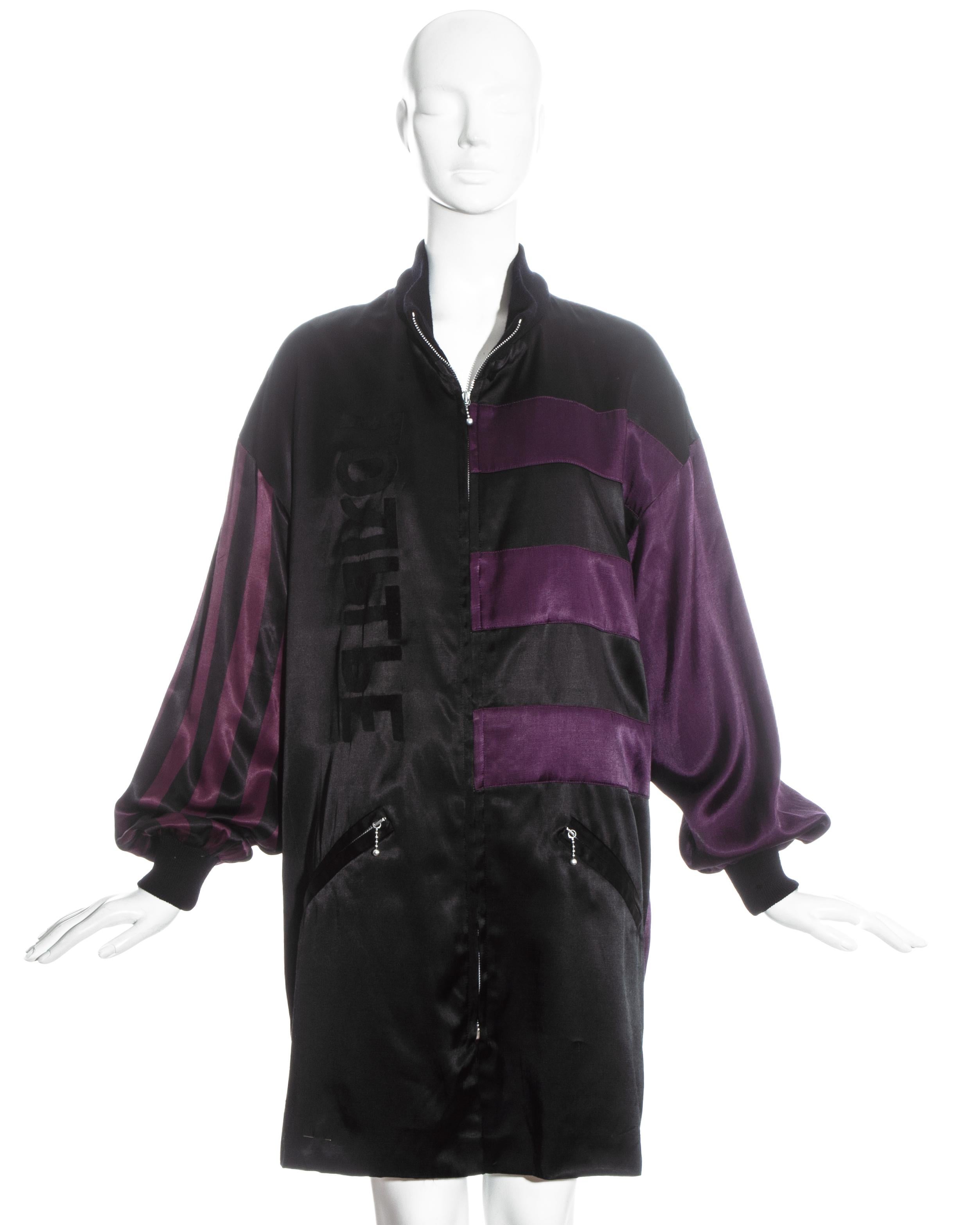 Veste oversize en satin rayé violet et noir Jean Paul Gaultier avec col et poignets en laine côtelée, deux poches avant et fermeture éclair.

Automne-Hiver 1986