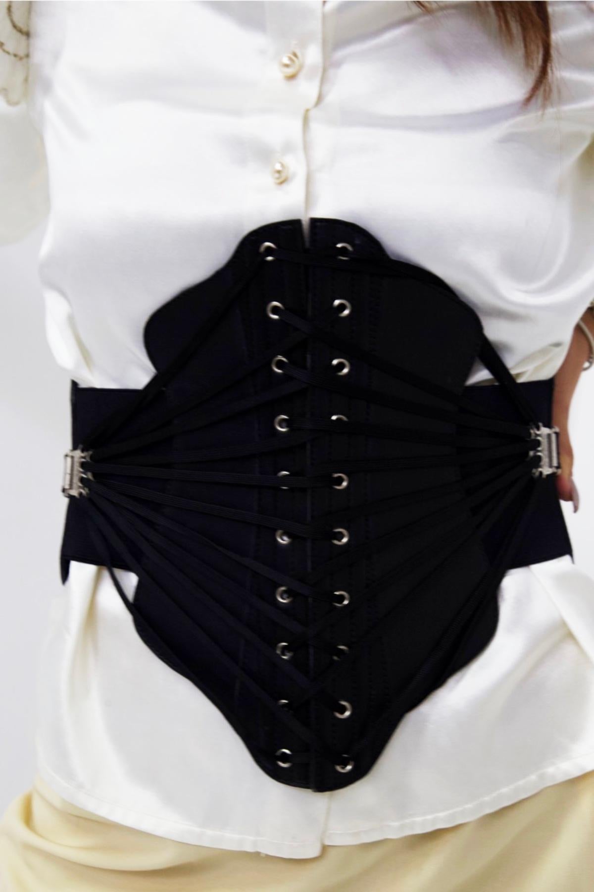 Very rare corset belt designed by Jean Paul Gaultier in the 1980s, made in France.
ORIGINAL LABEL.
The belt is really wide and takes up the whole bodice, so much so that one of its main uses is to act as a corset.
The belt is entirely made of shiny