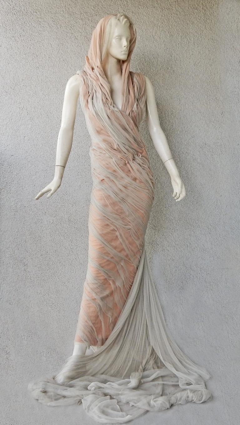 Haute Couture Gaultier hooded hourglass evening dress swathed in a 2 tone grey and soft peach silk.  Pale grey silk chiffon tails fall lightly against the dress.    The look is an evening gown with a boudoir feel of the 1930's.  Dress has an