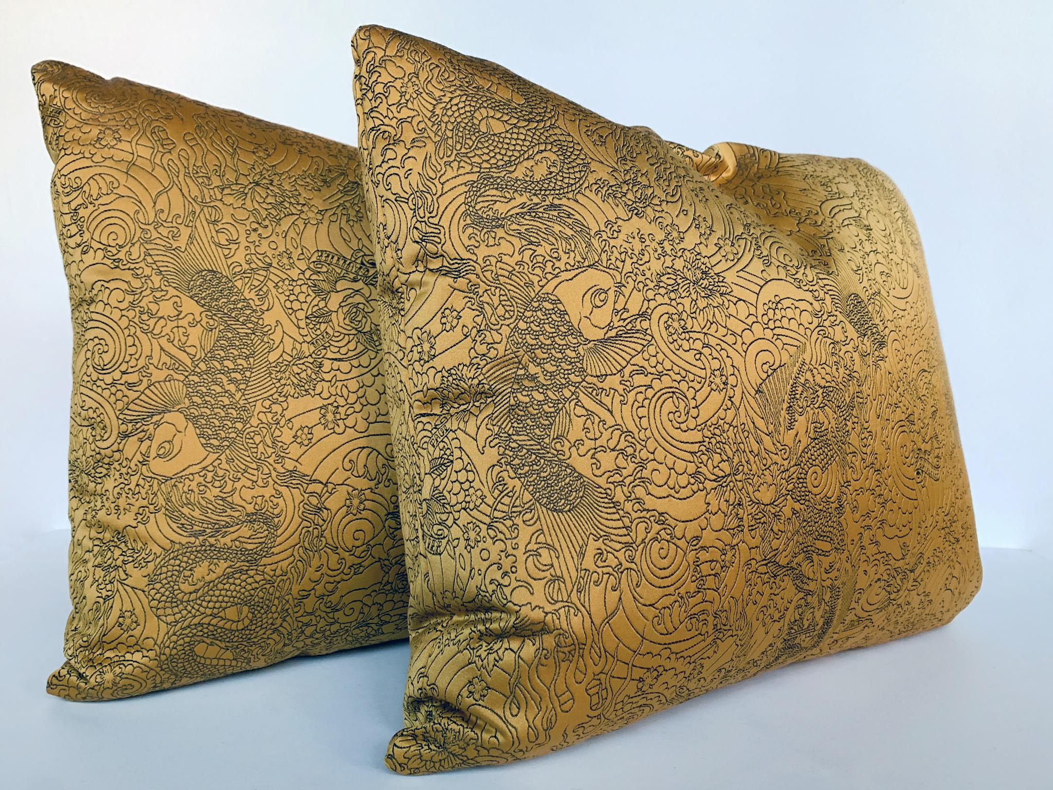 A new pair of custom-made rectangular pillows by Cafiero Select in a stunning gold satin from Jean Paul Gaultier. The fabric is intricately embroidered with a Chinoiserie pattern that sprawls beautifully across the entire surface. The cushion is a