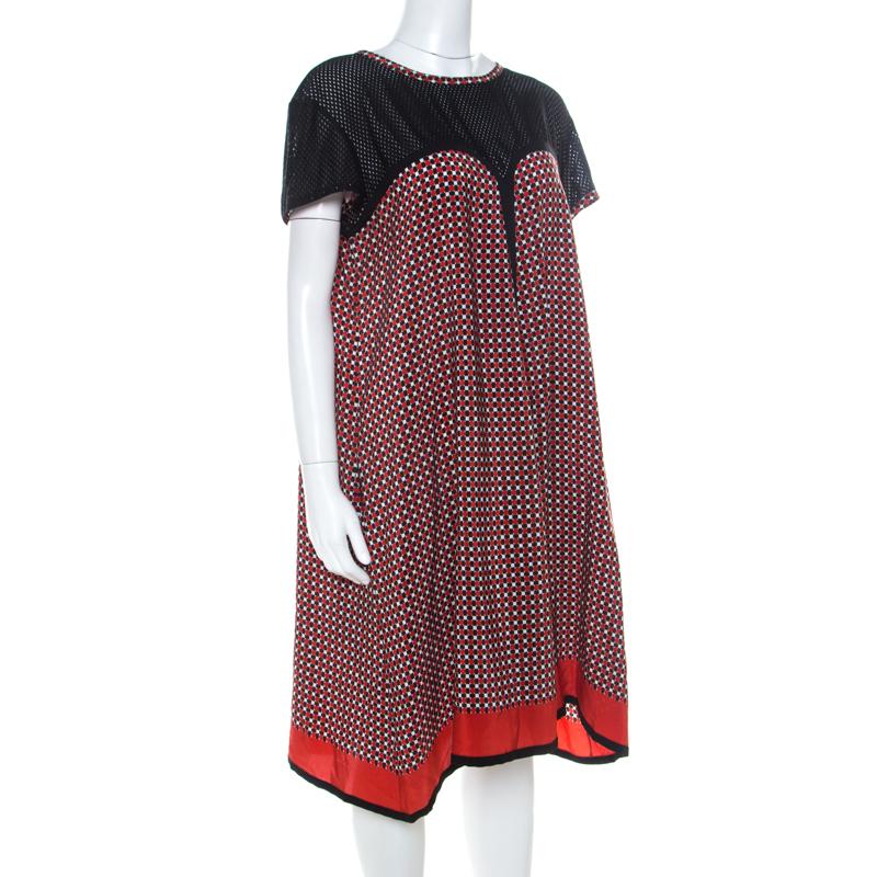 If you're looking for a chic yet casual number, you cannot go wrong with this Jean Paul Gaultier dress. It features perforated accents, geometric patterns and a back zipper. It can be worn with a pair of leather ankle strap flats or ballet flats.

