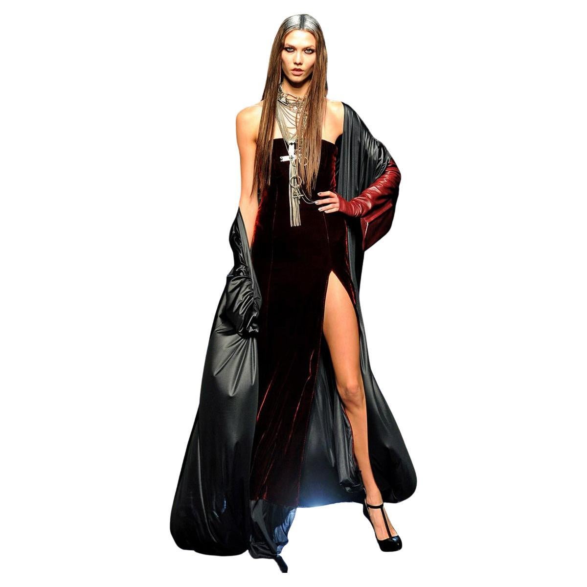 Rare and dramatic Jean Paul Gaultier 2 in 1 gown with attached evening coat/evening dress.  

Featured on the runway of the 2012 F/W collection.  Fashioned of black velvet in a strapless sheath with thigh high slit. Long evening coat is attached to