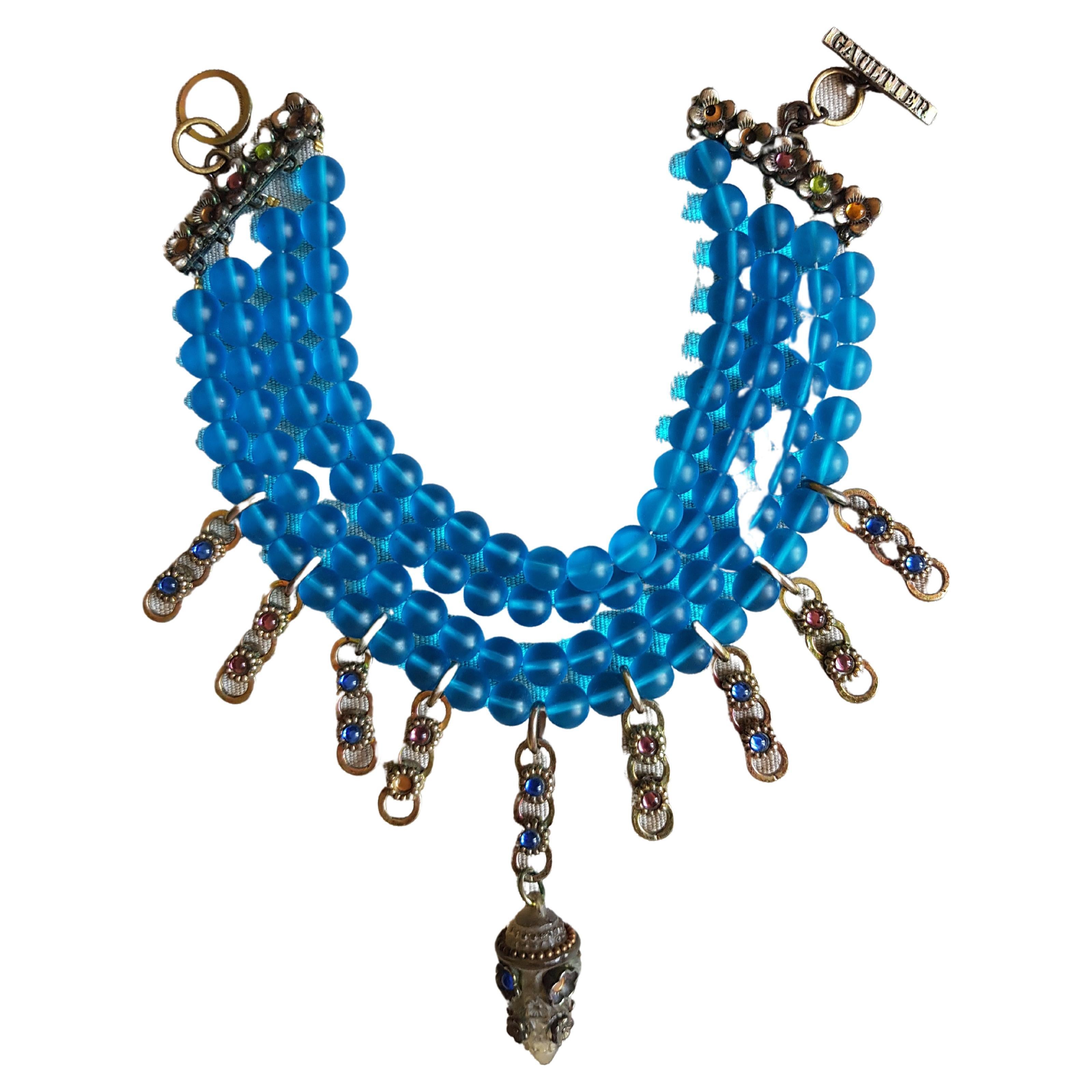 Punk beaded necklace choker by Jean Paul Gaultier most famous and iconic SS 1994 collection, worn by Rossy de Palma on runway.
- Turquoise frosted glass beads
- Gradual multi row
- Hooks and closing ring
- Signature Jean Paul Gaultier
- SS 1994
-