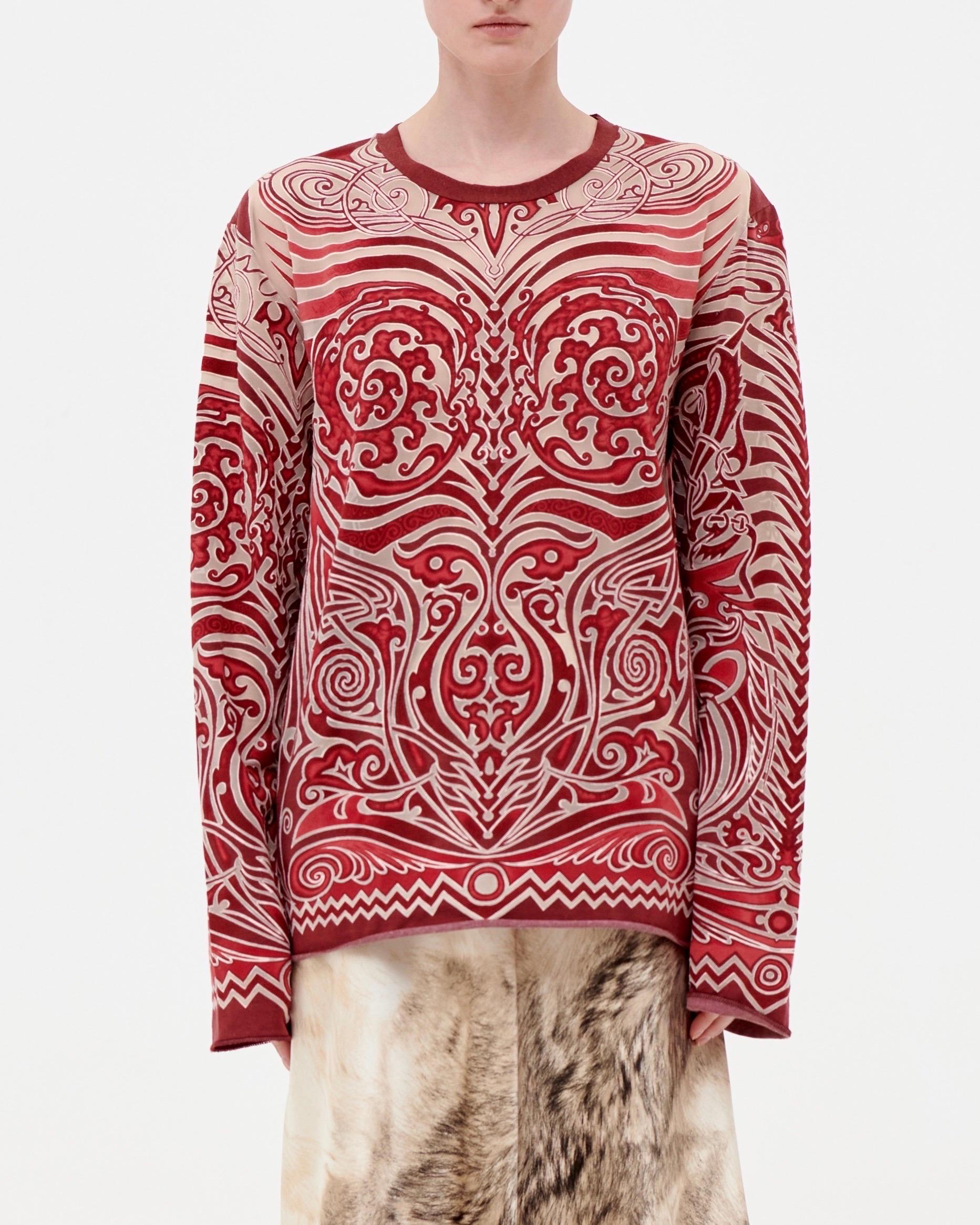 • Long sleeve top
• Red with mesh details
• Tribal dragon mesh motif