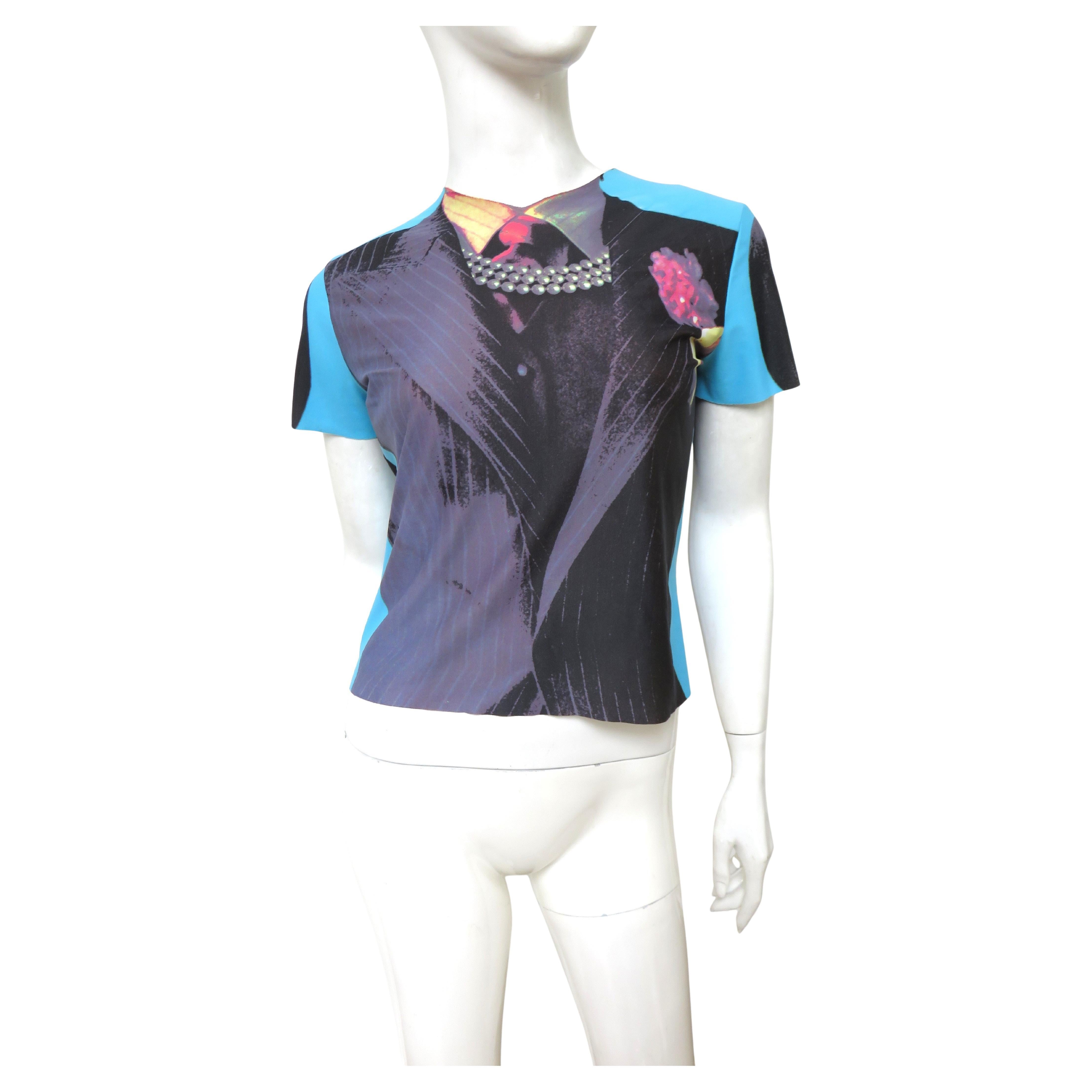 A stunning trompe l'oeil t-shirt, top in blue, grey and black from, Jean Paul Gaultier.  It has short sleeves, a crew neck and a fabulous trompe l'oeil pearl necklace, necktie and pinstripe lapels (the back is pinstriped). It has stretch and slips