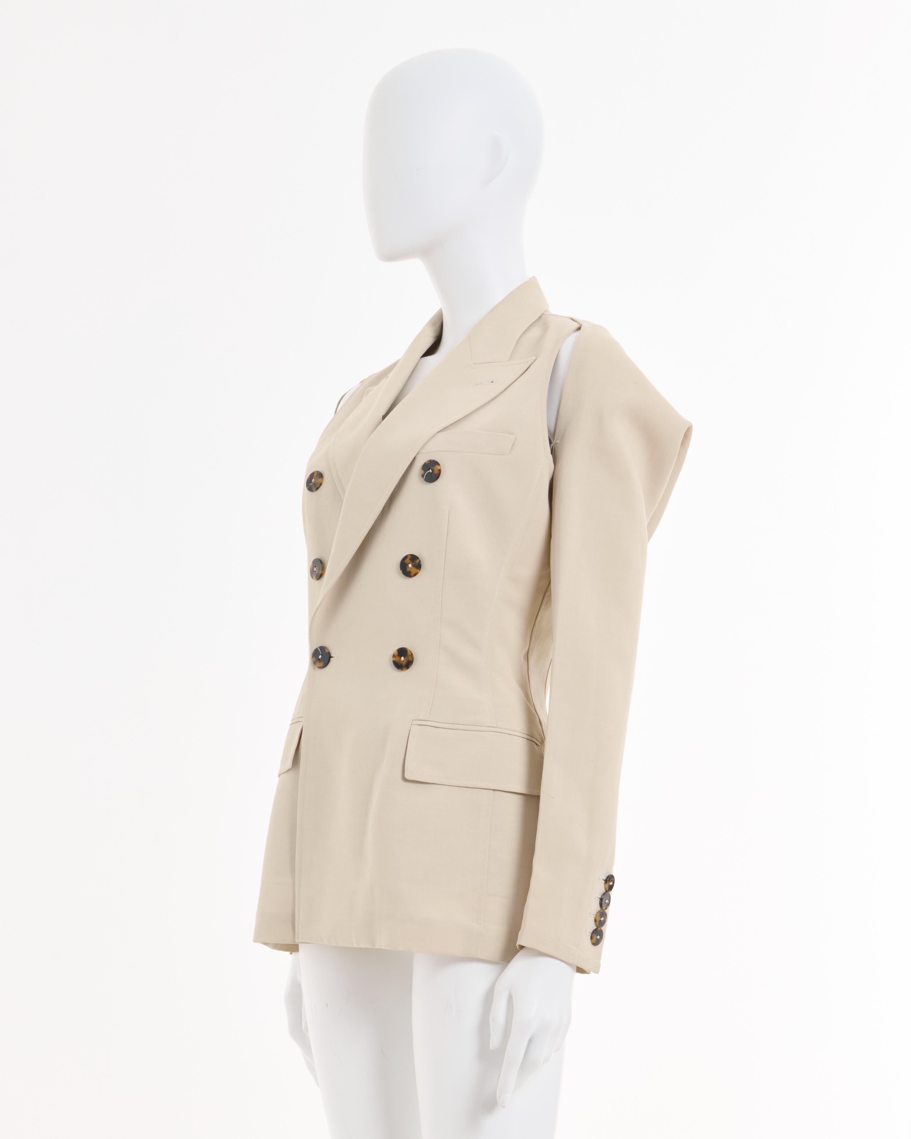 - Archival Jean Paul Gaultier cream double breasted blazer jacket with bolero sleeve-jacket attached with a button on the back 
- Sold by Skof.Archive
- Fall-Winter 1997/98
- Two pieces jacket 
- Two frontal pocket 
- Made in Italy 
- Materials: 52%