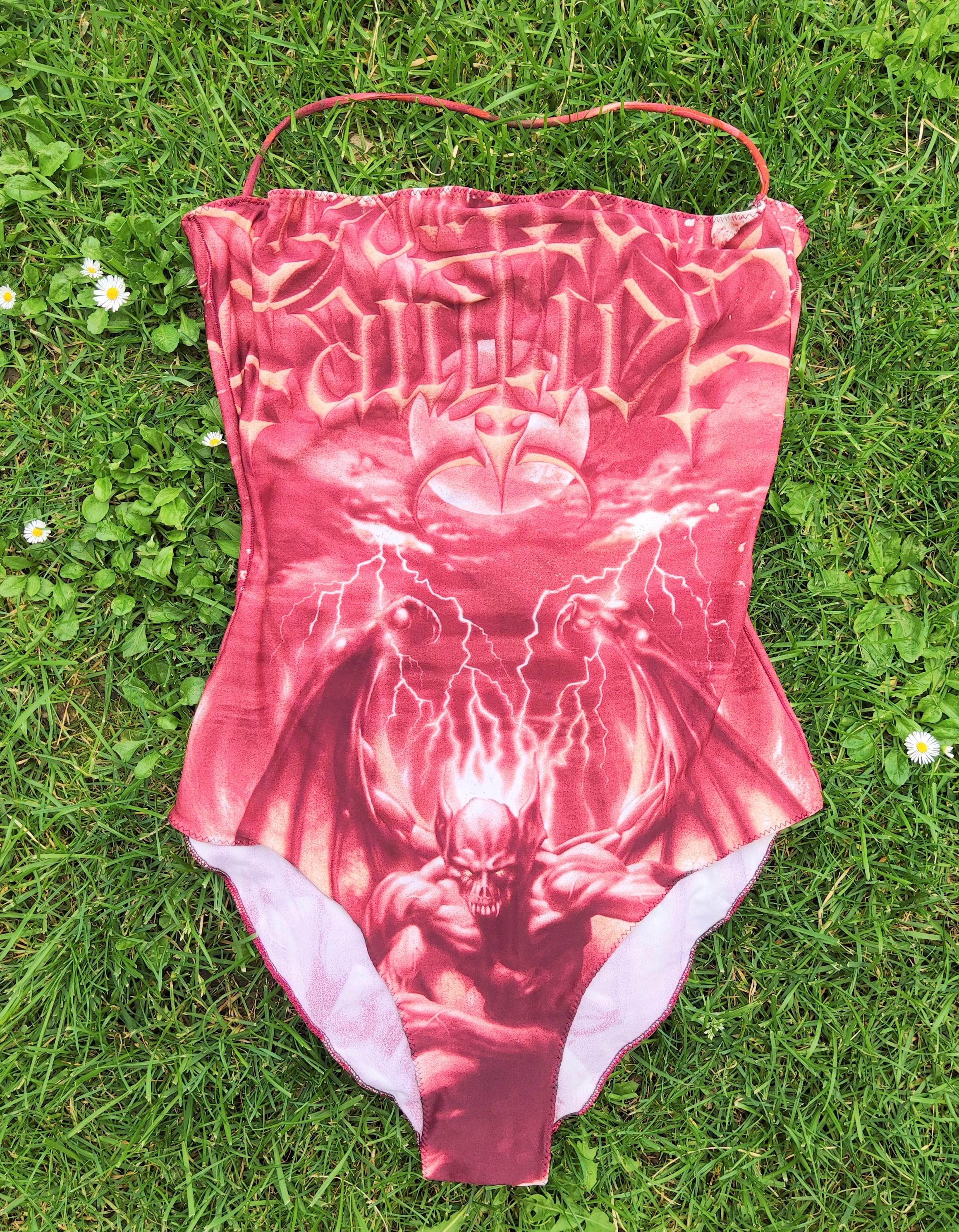 Iconic Satan swimsuit by Jean Paul Gaultier!

References shaped his Spring/Summer 2001 collection, as proven by the show’s invitational that was adorned with Rock motifs such as Skulls, Bats, and Infernal Flames. To that effect, the desired