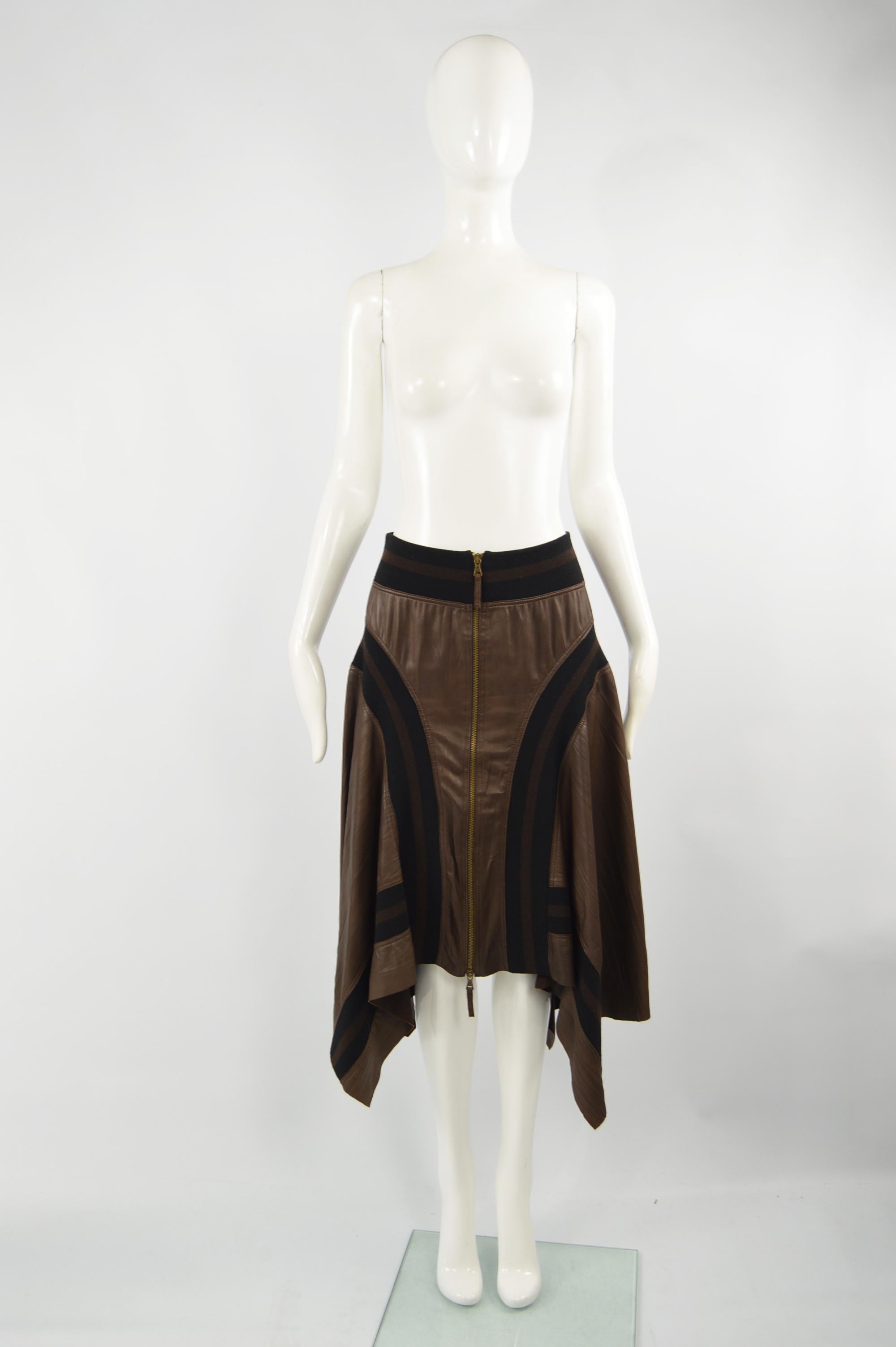 Jean Paul Gaultier Brown Sheepskin Leather Vintage Asymmetrical Hem Skirt, 1990s

Size: Marked I 44 / D 40 / F 40 / GB 12 / US 10 
Waist - Stretches up to 32” / 81cm
Hips - Up to 52” / 132cm
Length (Waist to Hem) - 33” / 84cm

Condition: Very Good
