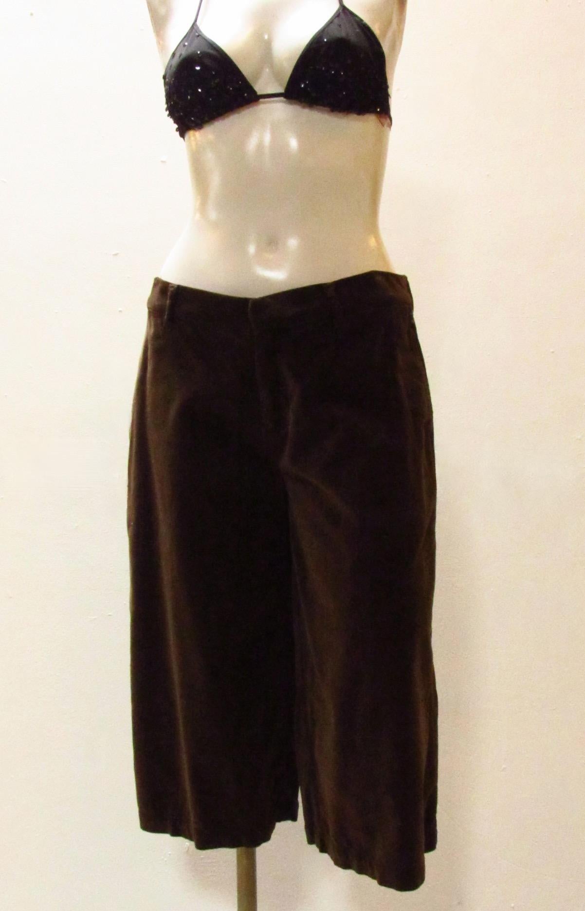 Chocolatey brown velvet knee length shorts from vintage Jean Paul Gaultier. Two slit side pockets as well as two back pockets adorned with embroidery. A buckle at back allows you to cinch fabric for fit. 